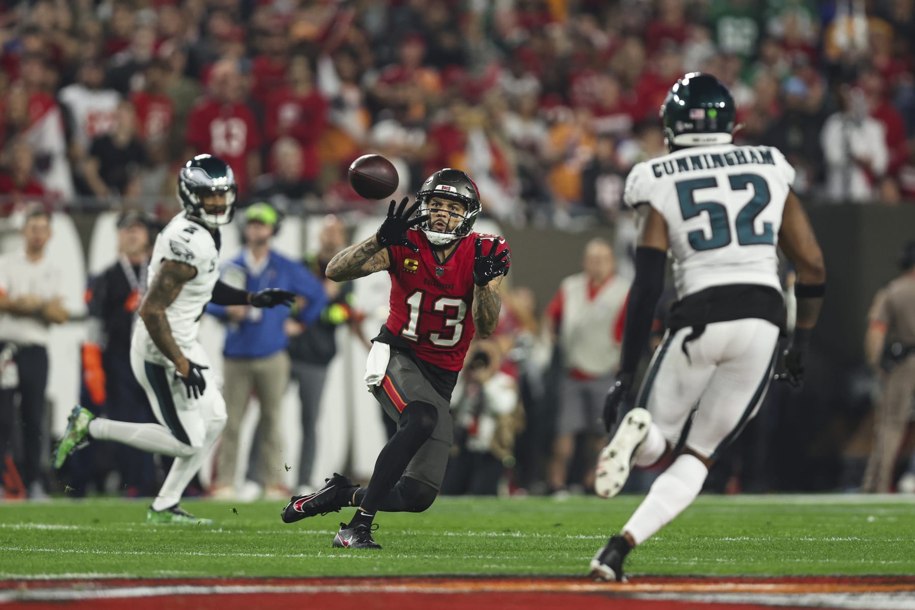 TAMPA, FL - JANUARY 15: Mike Evans #13 of the Tampa Bay Buccaneers tracks the ball during an NFL Wild Card playoff football game against the Philadelphia Eagles at Raymond James Stadium on January 15, 2024 in Tampa, Florida. (Photo by Perry Knotts/Getty Images)