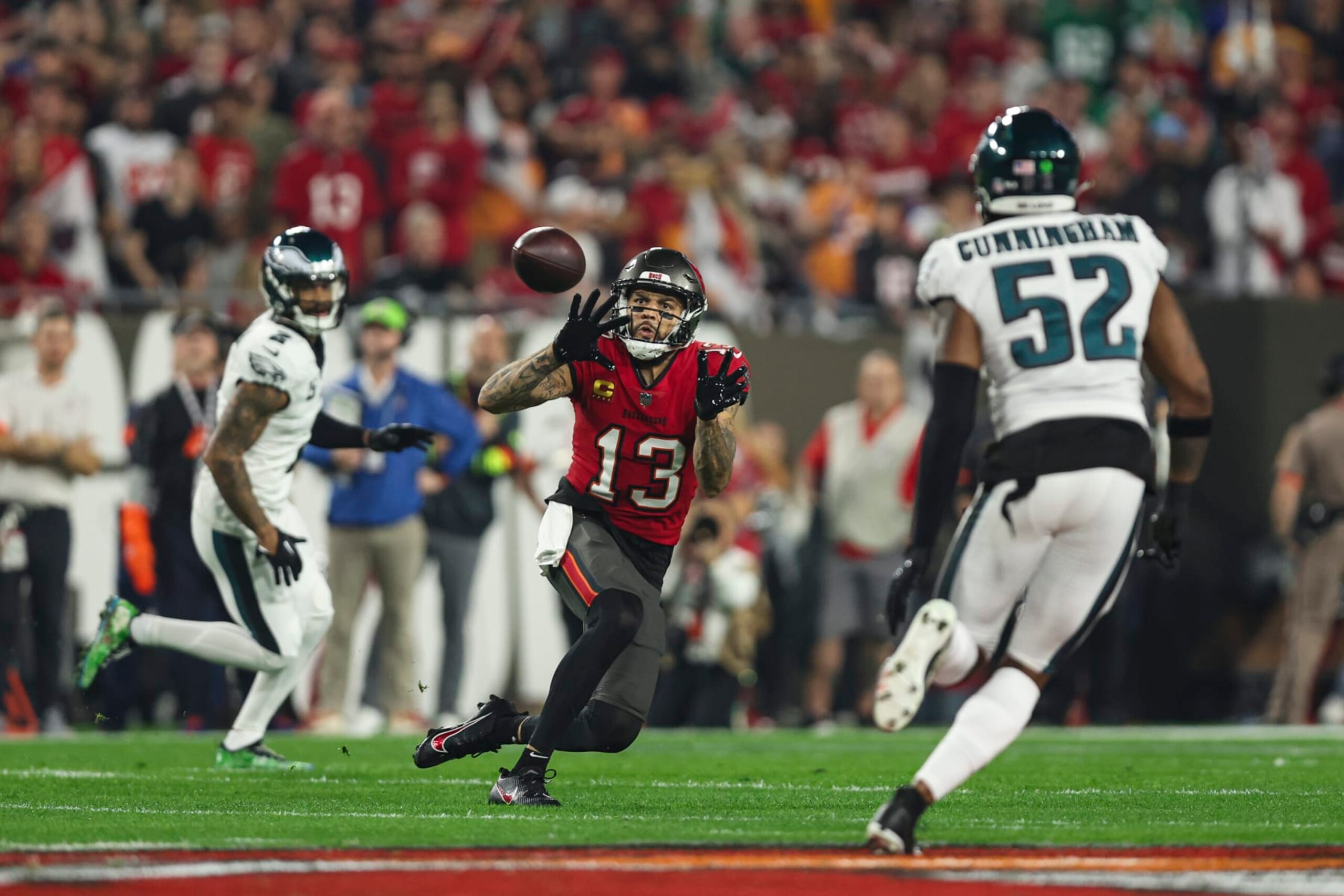 TAMPA, FL - JANUARY 15: Mike Evans #13 of the Tampa Bay Buccaneers tracks the ball during an NFL Wild Card playoff football game against the Philadelphia Eagles at Raymond James Stadium on January 15, 2024 in Tampa, Florida. (Photo by Perry Knotts/Getty Images)