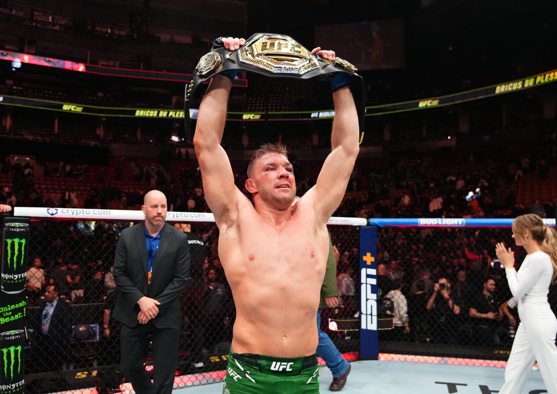 Dricus Du Plessis hoists the UFC middleweight belt into the air. 
