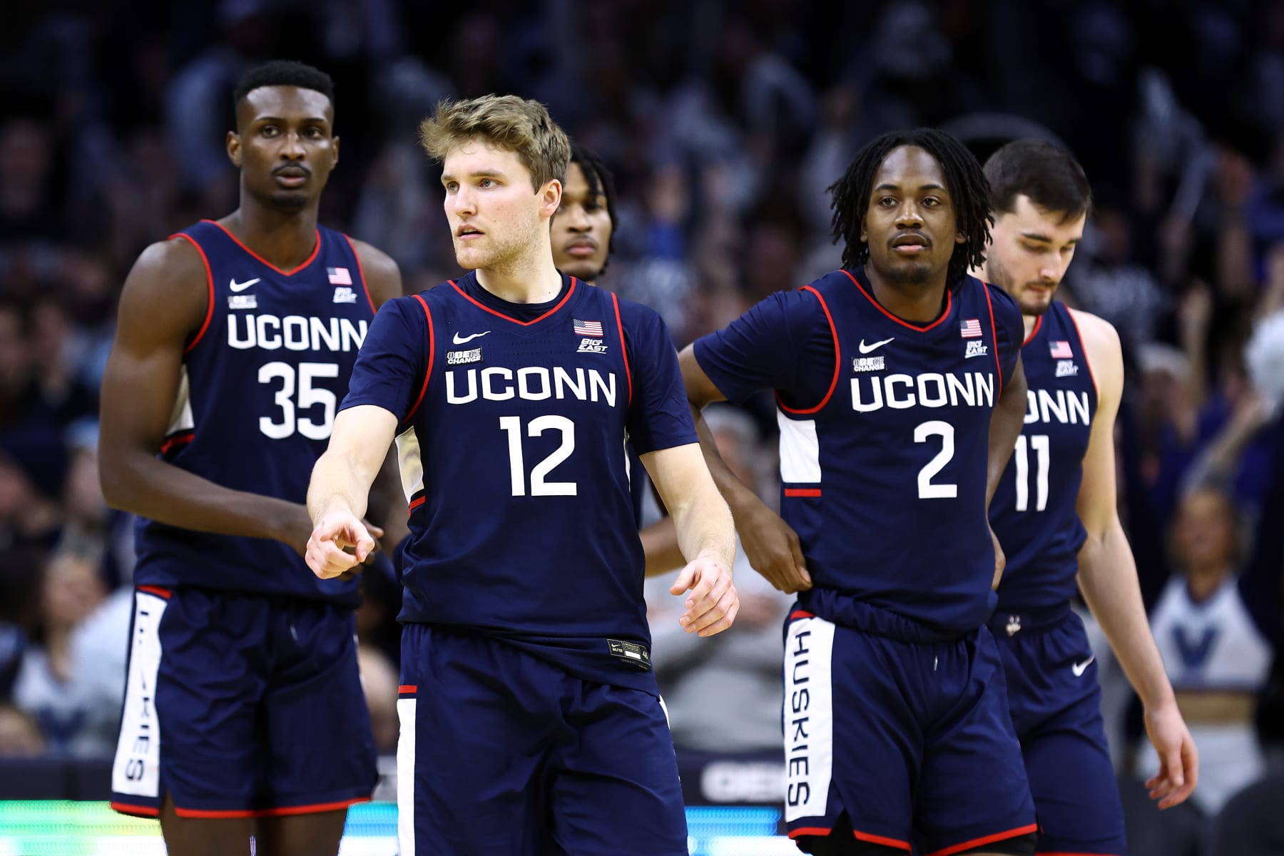 PHILADELPHIA, PENNSYLVANIA - JANUARY 20: Cam Spencer #12 of the Connecticut Huskies (C) looks on with teammates during the second half against the Villanova Wildcats  at the Wells Fargo Center on January 20, 2024 in Philadelphia, Pennsylvania. (Photo by Tim Nwachukwu/Getty Images)