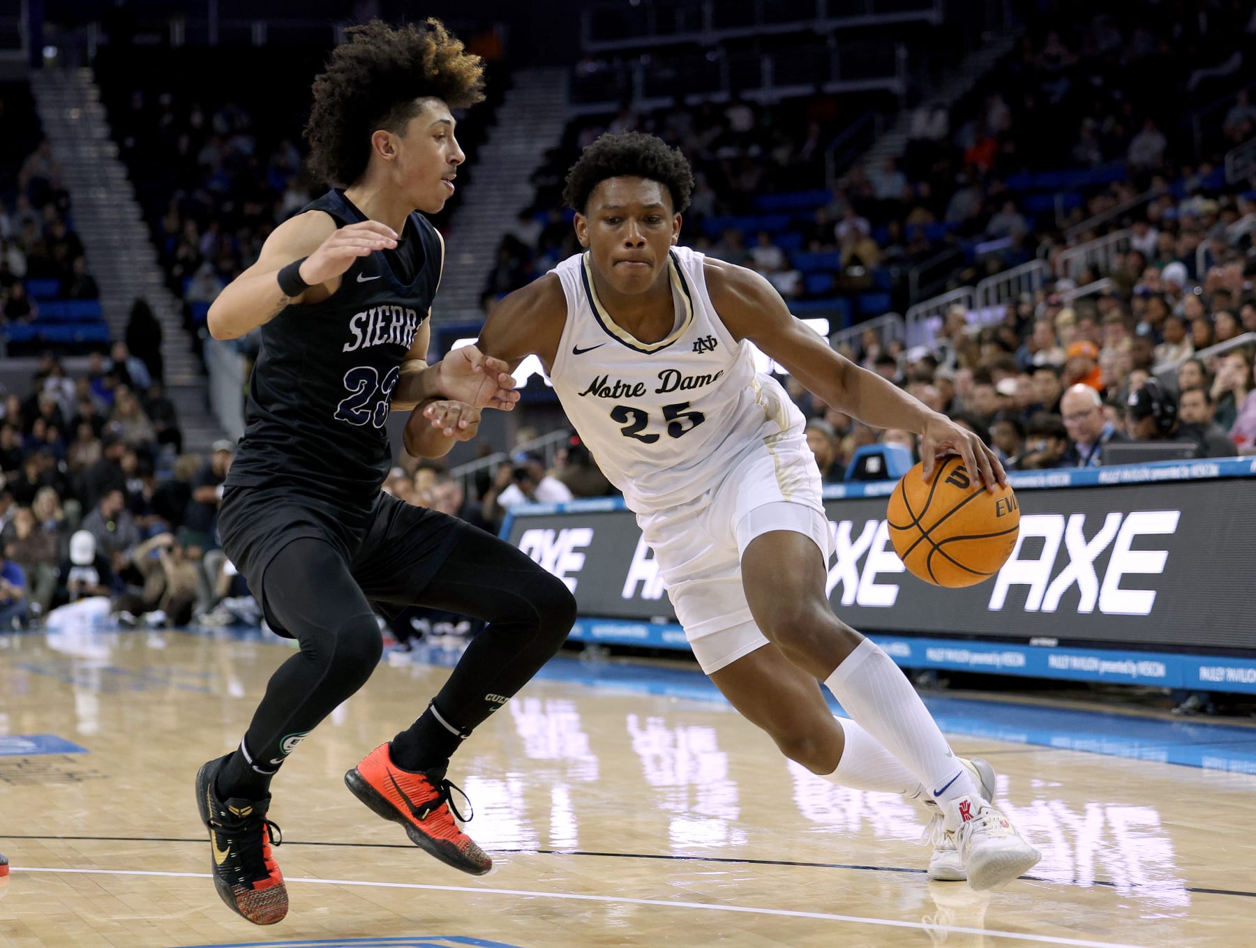 LOS ANGELES, CALIFORNIA - JANUARY 27: Mercy Miller #25 of the Notre Dame Knights drives to the basket on Dylan Metoyer #23 of the Sierra Canyon Trailblazers during a 66-62 Knights win at UCLA Pauley Pavilion on January 27, 2023 in Los Angeles, California. (Photo by Harry How/Getty Images)