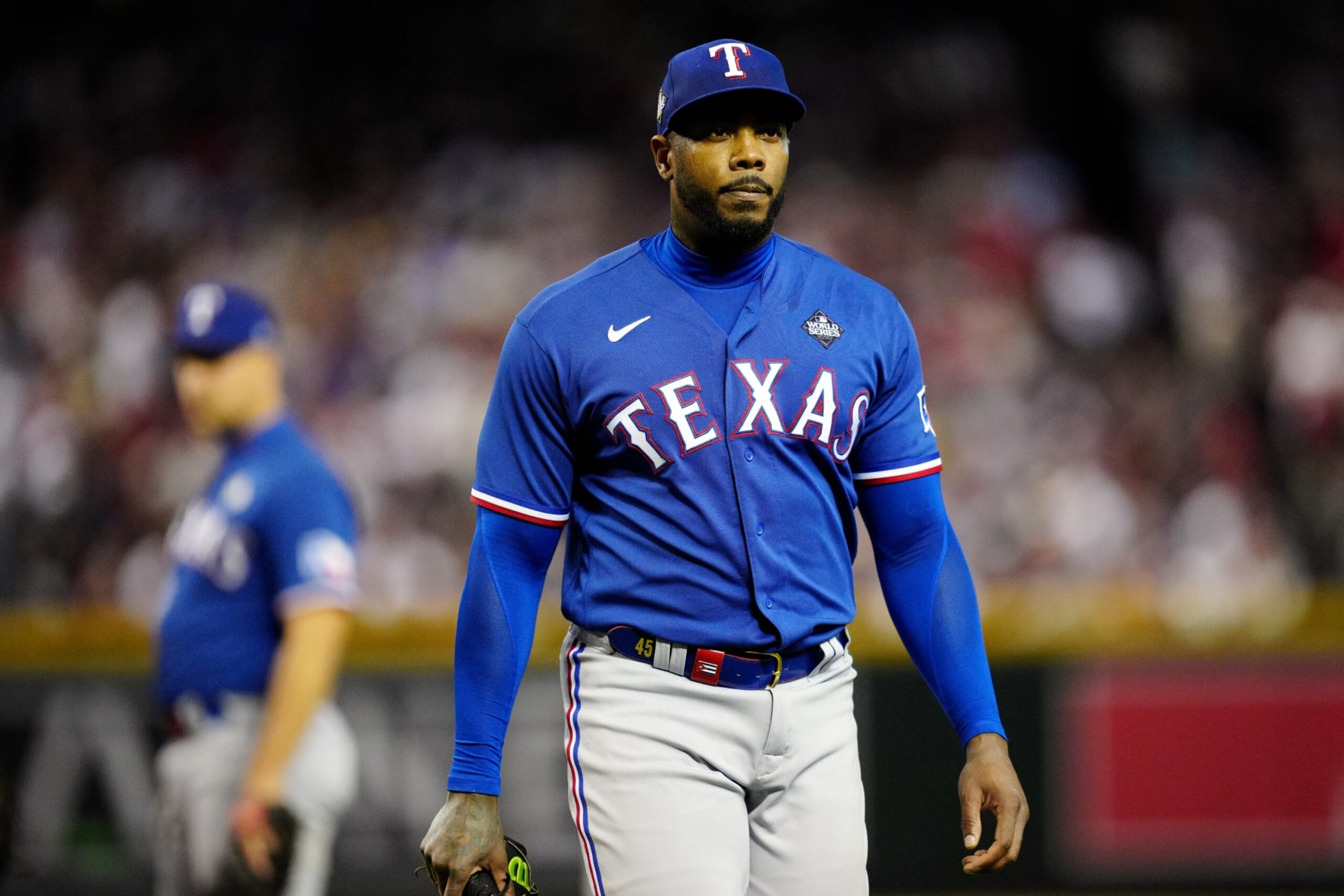 PHOENIX, AZ - NOVEMBER 01:  Aroldis Chapman #45 of the Texas Rangers walks back to the dugout during a pitching change during Game 5 of the 2023 World Series between the Texas Rangers and the Arizona Diamondbacks at Chase Field on Wednesday, November 1, 2023 in Phoenix, Arizona. (Photo by Mary DeCicco/MLB Photos via Getty Images)