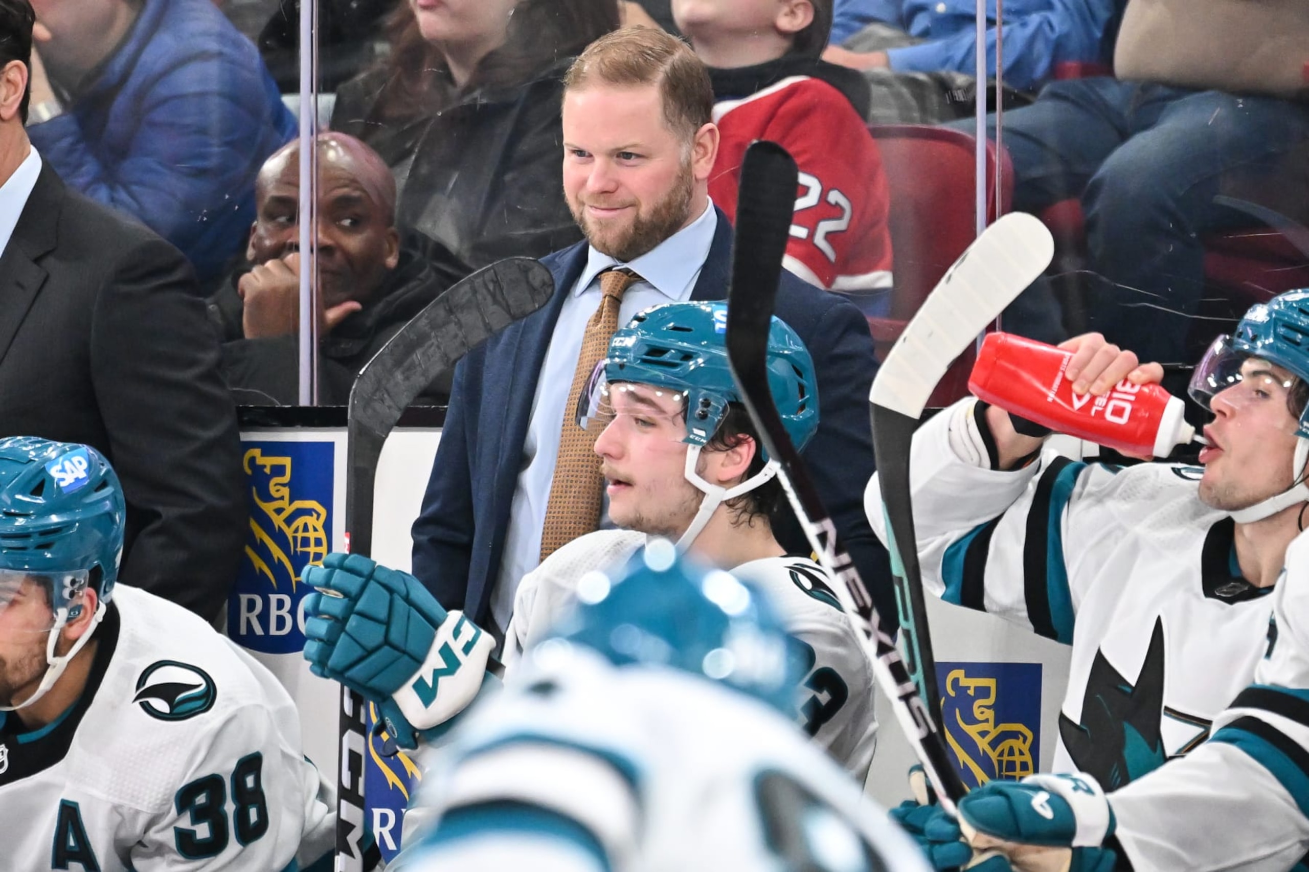 MONTREAL, CANADA - JANUARY 11:  Assistant coach of the San Jose Sharks Ryan Warsofsky, handles bench duties during the second period against the Montreal Canadiens at the Bell Centre on January 11, 2024 in Montreal, Quebec, Canada.  The San Jose Sharks defeated the Montreal Canadiens 3-2.  (Photo by Minas Panagiotakis/Getty Images)