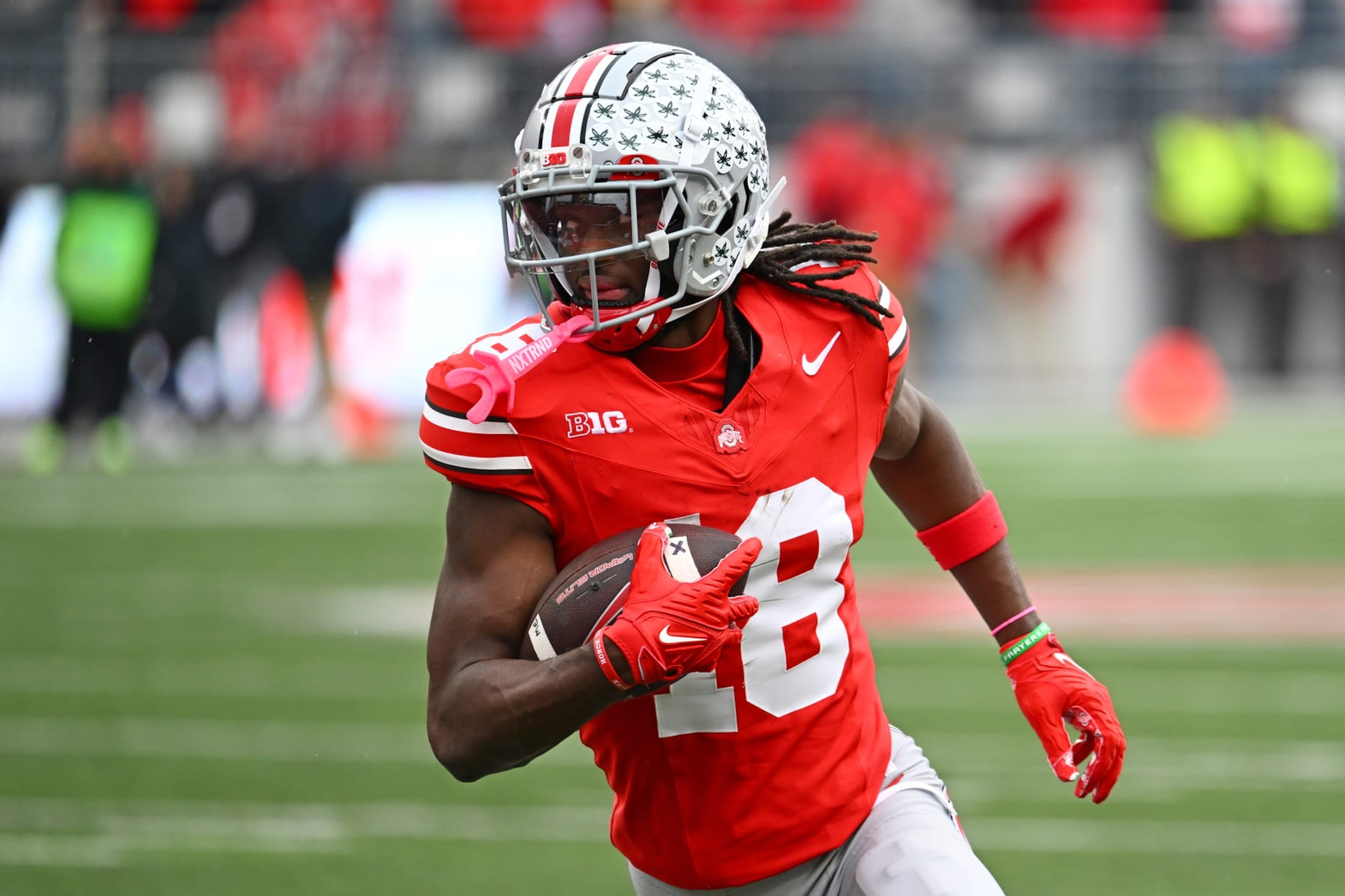 COLUMBUS, OHIO - OCTOBER 21: Marvin Harrison Jr. #18 of the Ohio State Buckeyes runs with the ball during the fourth quarter of a game against the Penn State Nittany Lions at Ohio Stadium on October 21, 2023 in Columbus, Ohio. (Photo by Ben Jackson/Getty Images)