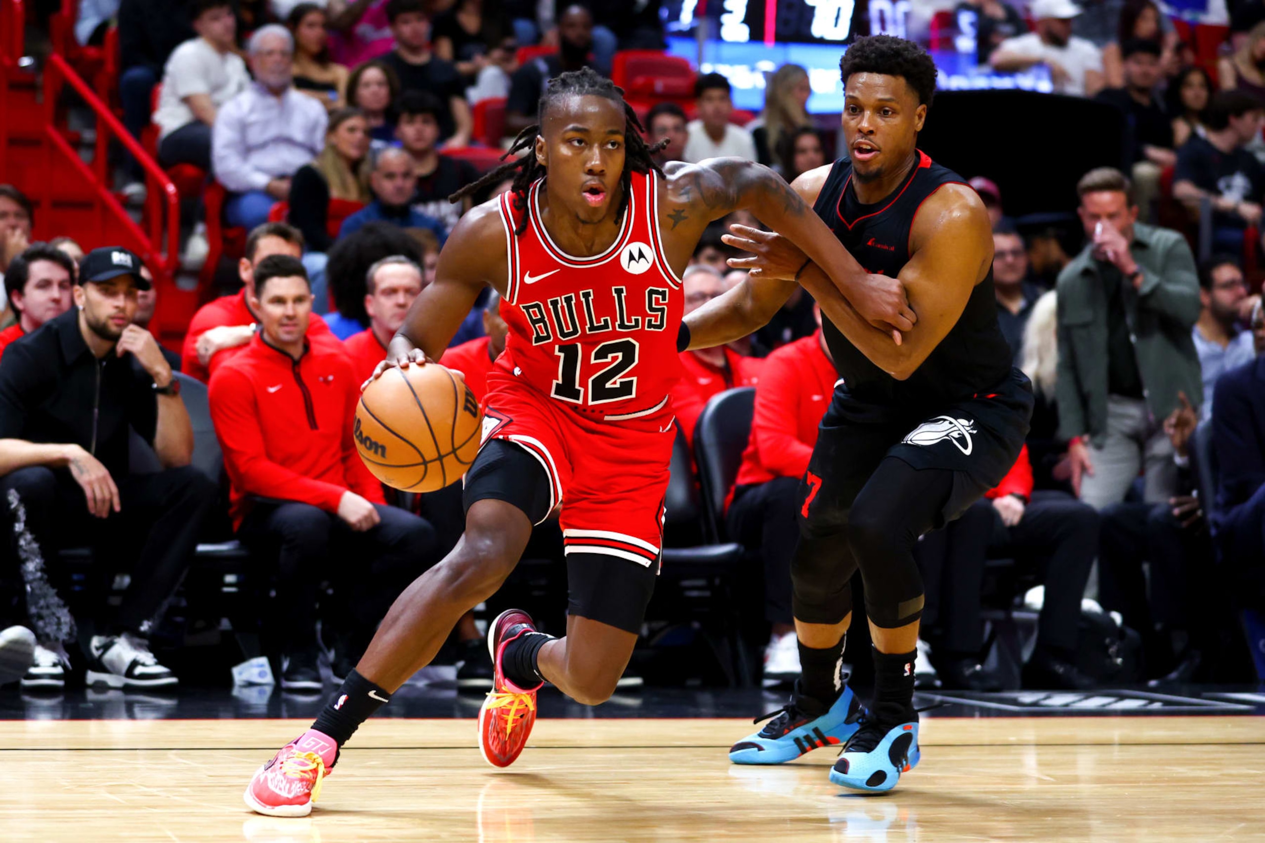 MIAMI, FLORIDA - DECEMBER 16: Ayo Dosunmu #12 of the Chicago Bulls drives against Kyle Lowry #7 of the Miami Heat during the third quarter of the game at Kaseya Center on December 16, 2023 in Miami, Florida. NOTE TO USER: User expressly acknowledges and agrees that, by downloading and or using this photograph, User is consenting to the terms and conditions of the Getty Images License Agreement. (Photo by Megan Briggs/Getty Images)