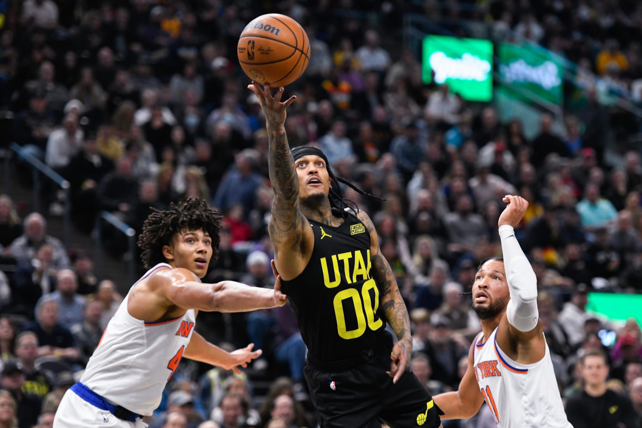 SALT LAKE CITY, UTAH - NOVEMBER 15: Jordan Clarkson #00 of the Utah Jazz shoots between Jericho Sims #45 and Jalen Brunson #11 of the New York Knicks during a game at Vivint Arena on November 15, 2022 in Salt Lake City, Utah. NOTE TO USER: User expressly acknowledges and agrees that, by downloading and or using this photograph, User is consenting to the terms and conditions of the Getty Images License Agreement. (Photo by Alex Goodlett/Getty Images)