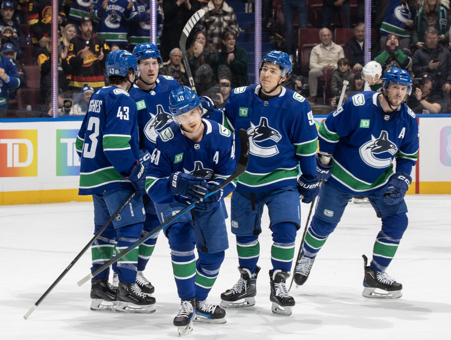VANCOUVER, CANADA - JANUARY 18: Elias Pettersson #40 of the Vancouver Canucks skates back to the bench to celebrate his goal with teammates during the first period of their NHL game against the Arizona Coyotes at Rogers Arena on January 18, 2024 in Vancouver, British Columbia, Canada.  (Photo by Jeff Vinnick/NHLI via Getty Images)
