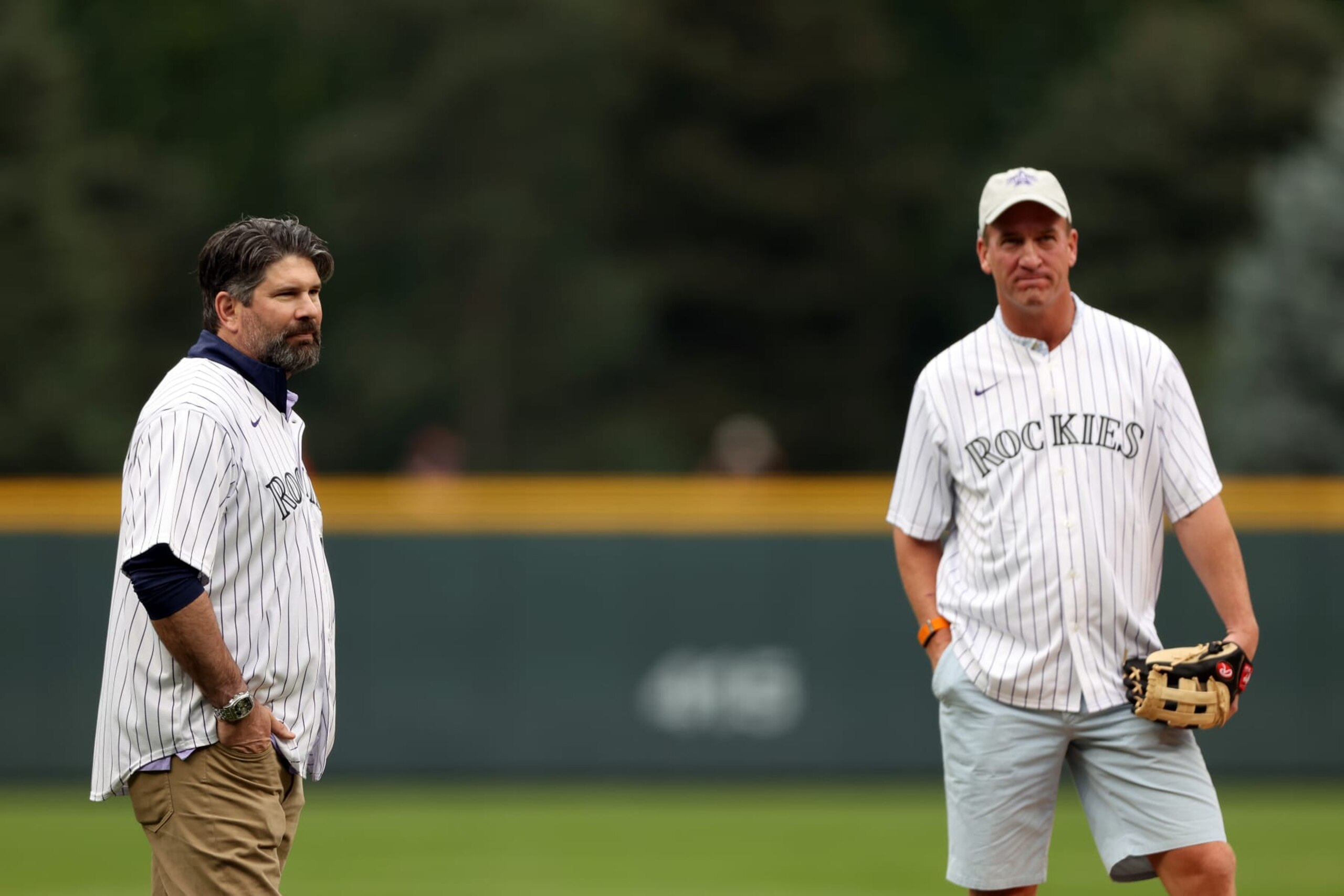 DENVER, COLORADO - JULY 13: Former Colorado Rockie Todd Helton and former NFL quarterback Peyton Manning take the field for the ceremonial first pitch ahead of the 91st MLB All-Star Game at Coors Field on July 13, 2021 in Denver, Colorado. (Photo by Alex Trautwig/Getty Images)