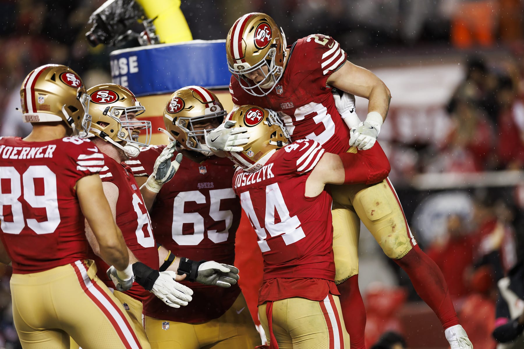 SANTA CLARA, CALIFORNIA - JANUARY 20: Christian McCaffrey #23 of the San Francisco 49ers celebrates with the team after scoring a touchdown during an NFC divisional round playoff football game against the Green Bay Packers at Levi's Stadium on January 20, 2024 in Santa Clara, California. (Photo by Ryan Kang/Getty Images)