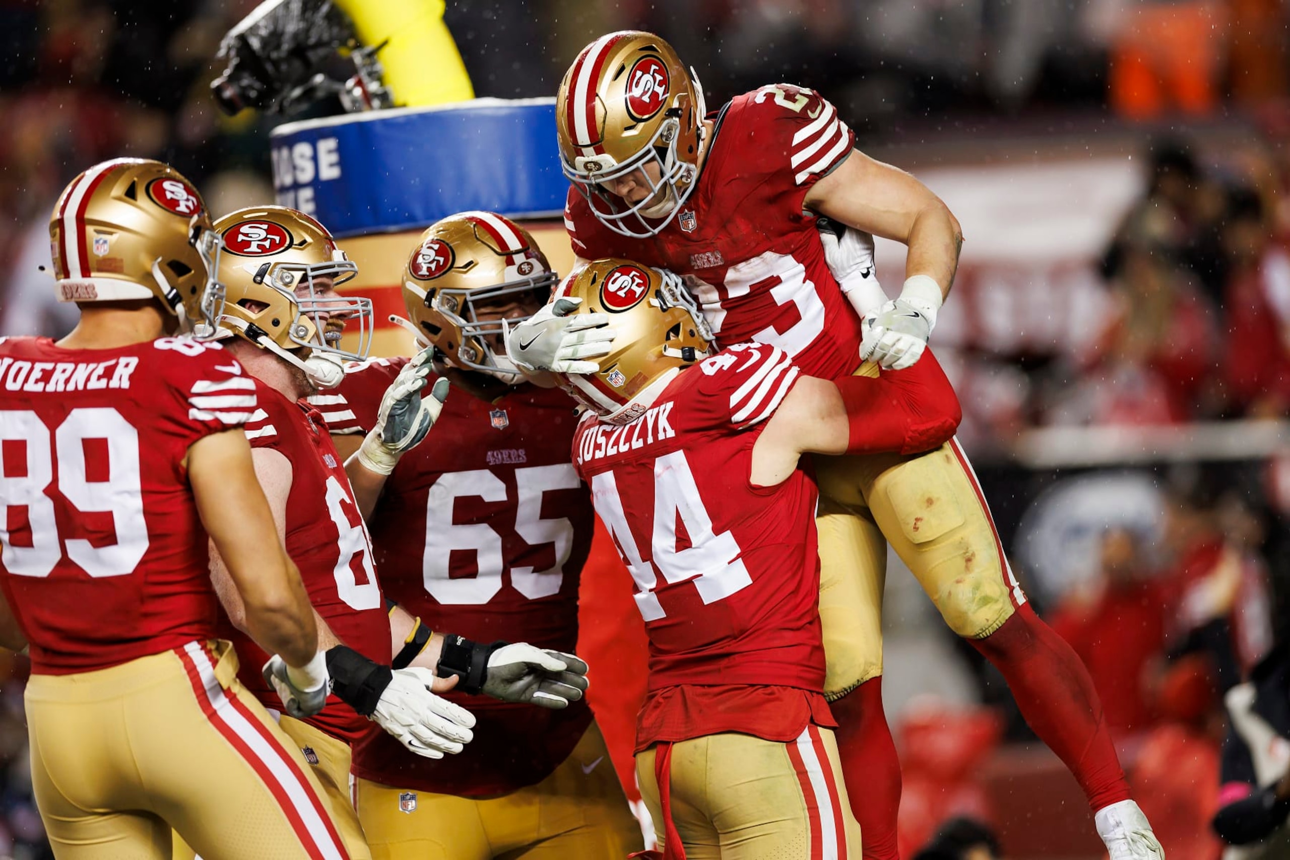 SANTA CLARA, CALIFORNIA - JANUARY 20: Christian McCaffrey #23 of the San Francisco 49ers celebrates with the team after scoring a touchdown during an NFC divisional round playoff football game against the Green Bay Packers at Levi's Stadium on January 20, 2024 in Santa Clara, California. (Photo by Ryan Kang/Getty Images)