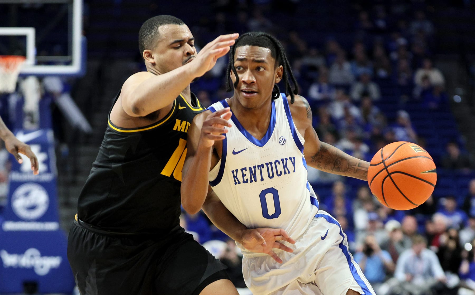LEXINGTON, KENTUCKY - JANUARY 09: Rob Dillingham #0 of the Kentucky Wildcats dribbles the ball while defended by Nick Honor #10 of the Missouri Tigers in the second half at Rupp Arena on January 09, 2024 in Lexington, Kentucky. (Photo by Andy Lyons/Getty Images)