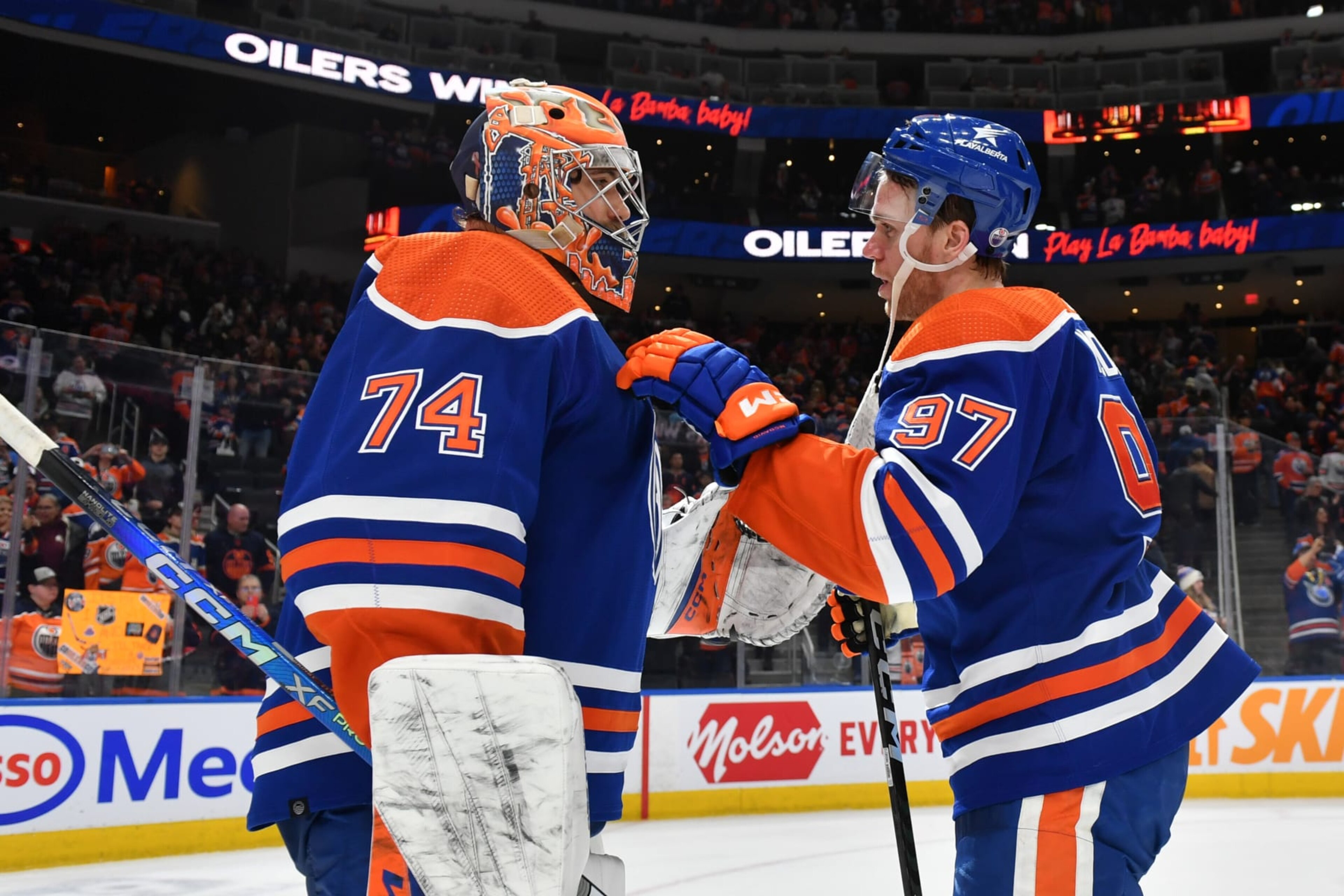 EDMONTON, CANADA - JANUARY 23: Connor McDavid #97 of the Edmonton Oilers celebrates the win over the Columbus Blue Jackets with goaltender Stuart Skinner #74 while congratulating him on setting the franchise record for consecutive wins by a goalie surpassing Grant Fuhr at Rogers Place on January 23, 2024, in Edmonton, Alberta, Canada. (Photo by Andy Devlin/NHLI via Getty Images)