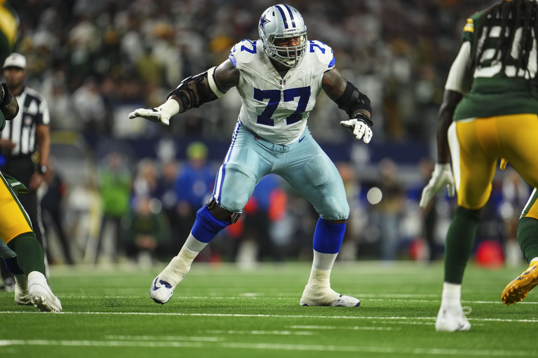 DALLAS, TX - JANUARY 14: Tyron Smith #77 of the Dallas Cowboys drops back to block during an NFL wild-card playoff football game against the Green Bay Packers at AT&T Stadium on January 14, 2024 in Dallas, Texas. (Photo by Cooper Neill/Getty Images)