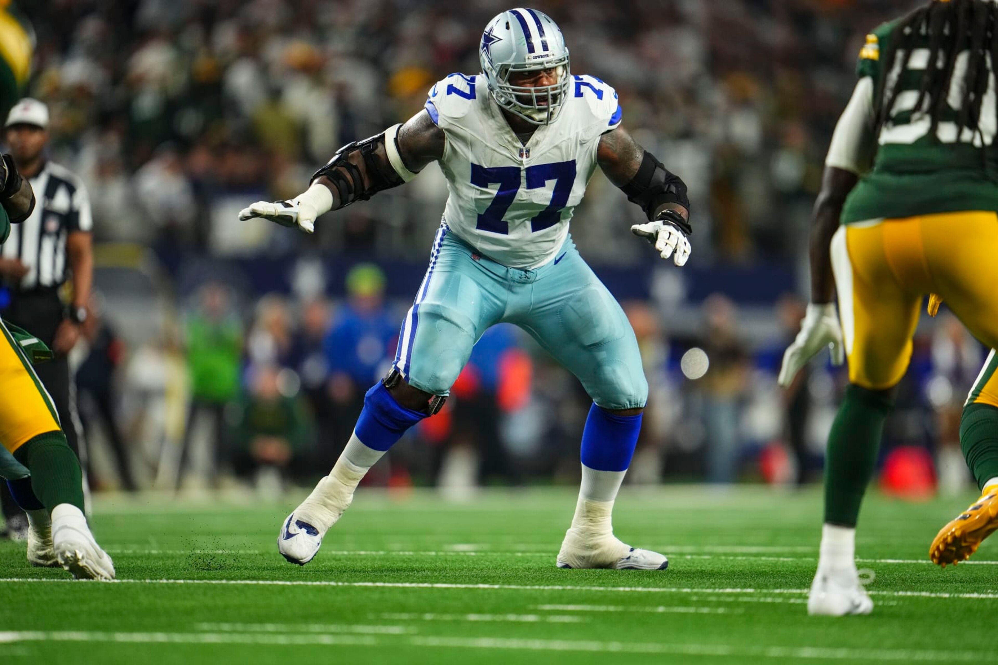 DALLAS, TX - JANUARY 14: Tyron Smith #77 of the Dallas Cowboys drops back to block during an NFL wild-card playoff football game against the Green Bay Packers at AT&T Stadium on January 14, 2024 in Dallas, Texas. (Photo by Cooper Neill/Getty Images) DALLAS, TX - JANUARY 14: Tyron Smith #77 of the Dallas Cowboys drops back to block during an NFL wild-card playoff football game against the Green Bay Packers at AT&T Stadium on January 14, 2024 in Dallas, Texas. (Photo by Cooper Neill/Getty Images)