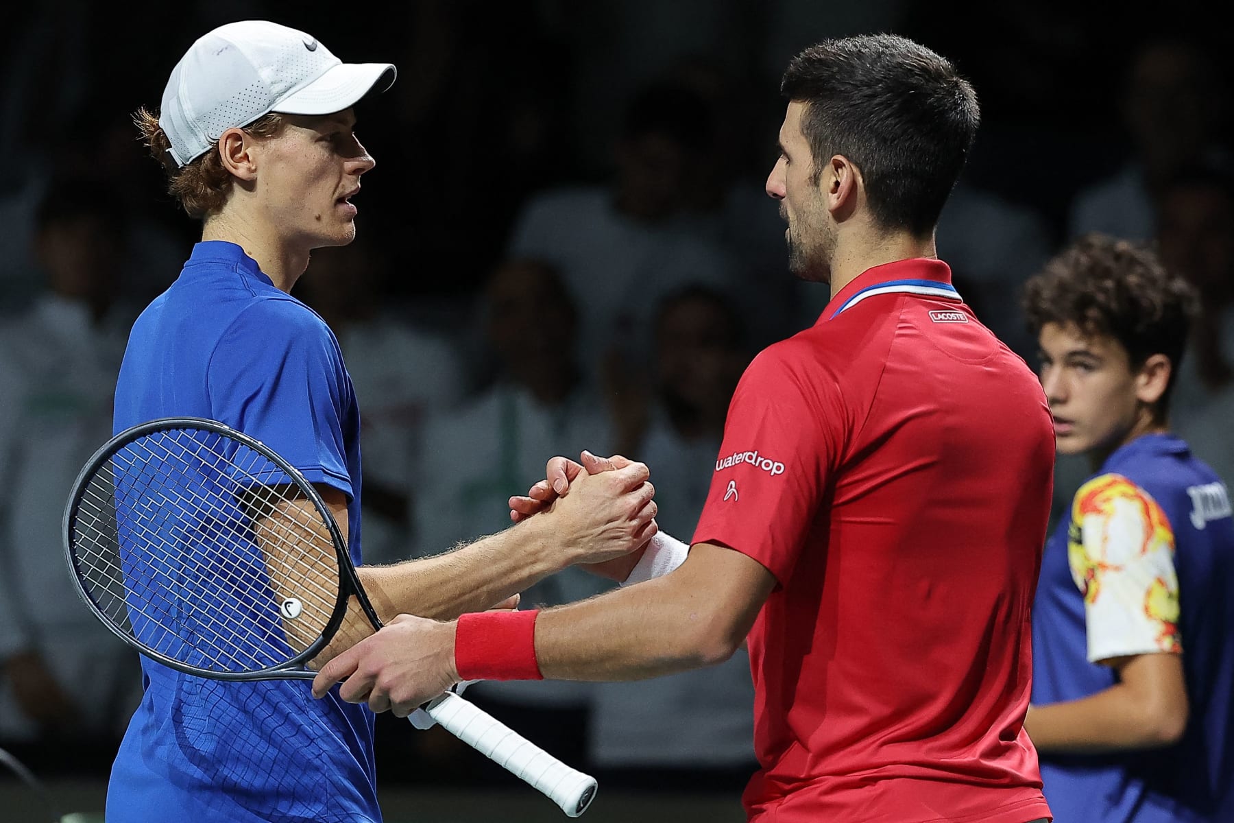 Italy's Jannik Sinner greets Serbia's Novak Djokovic after winning the second men's singles semifinal tennis match between Italy and Serbia of the Davis Cup tennis tournament at the Martin Carpena sportshall, in Malaga on November 25, 2023. (Photo by LLUIS GENE / AFP) (Photo by LLUIS GENE/AFP via Getty Images)