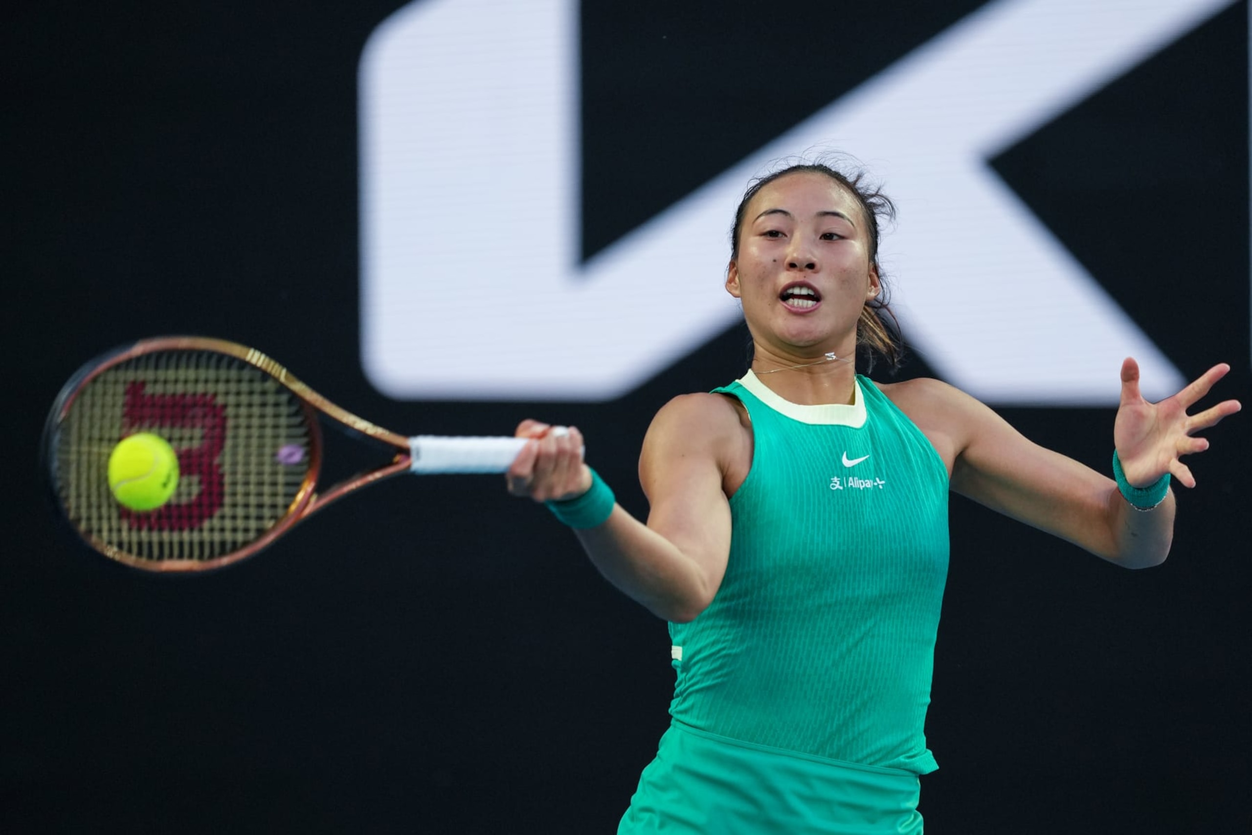MELBOURNE, AUSTRALIA - JANUARY 24: Qinwen Zheng of China plays a forehand in the Women's Singles Quarter Finals match against Anna Kalinskaya during day eleven of the 2024 Australian Open at Melbourne Park on January 24, 2024 in Melbourne, Australia. (Photo by Shi Tang/Getty Images)
