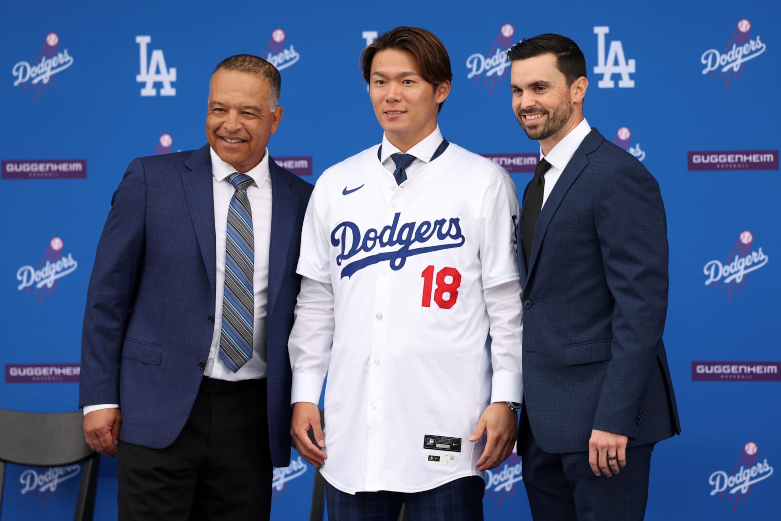 LOS ANGELES, CA - DECEMBER 27: Newly acquired Los Angeles Dodgers pitcher Yoshinobu Yamamoto (18) poses for a photo with manager Dave Roberts (left) and general manager Brandon Gomes (right) during an introductory press conference on December 27, 2023 at Dodger Stadium in Los Angeles, CA. (Photo by Kiyoshi Mio/Icon Sportswire via Getty Images)
