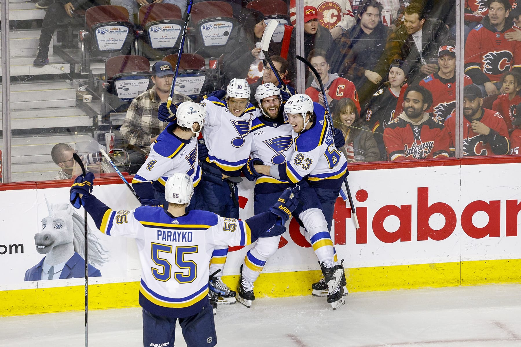 CALGARY, AB - JANUARY 23: Brayden Schenn #10, Brandon Saad #20, Jake Neighbours #63 of the St Louis Blues celebrate on ice after a goal against the Calgary Flames at Scotiabank Saddledome on January 23, 2024 in Calgary, Alberta, Canada. (Photo by Jenn Pierce/NHLI via Getty Images)