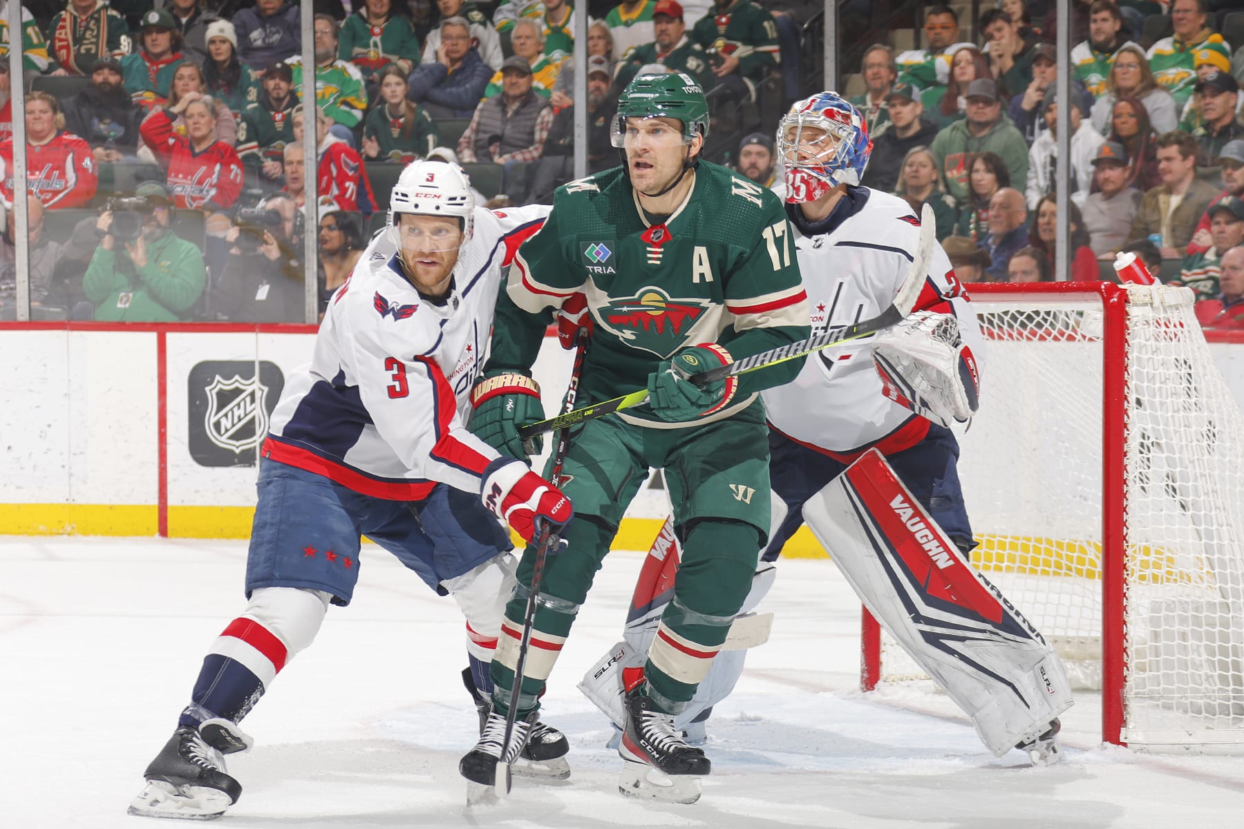 SAINT PAUL, MN - JANUARY 23: Nick Jensen #3 and Darcy Kuemper #35 of the Washington Capitals defend against Marcus Foligno #17 of the Minnesota Wild during the game at the Xcel Energy Center on January 23, 2024 in Saint Paul, Minnesota. (Photo by Bruce Kluckhohn/NHLI via Getty Images)