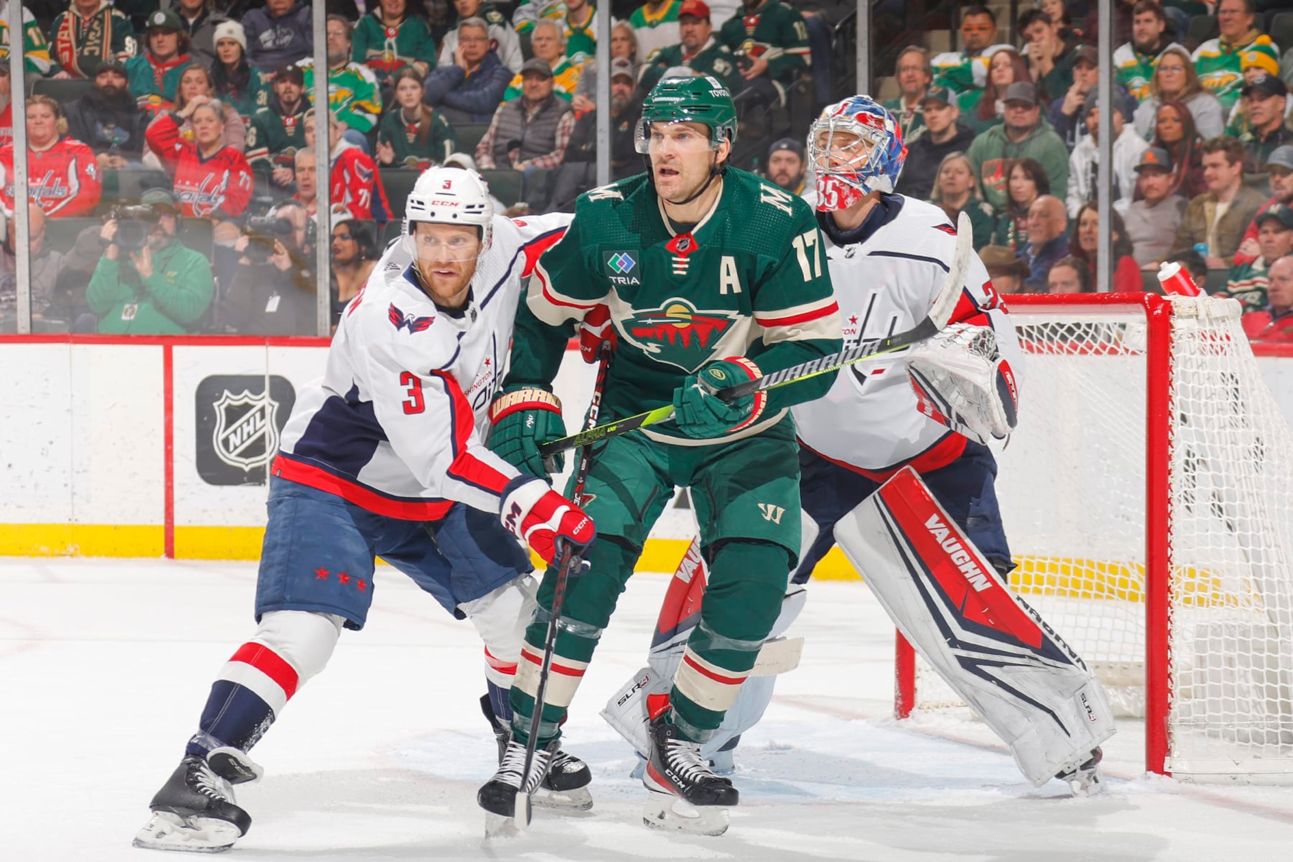 SAINT PAUL, MN - JANUARY 23: Nick Jensen #3 and Darcy Kuemper #35 of the Washington Capitals defend against Marcus Foligno #17 of the Minnesota Wild during the game at the Xcel Energy Center on January 23, 2024 in Saint Paul, Minnesota. (Photo by Bruce Kluckhohn/NHLI via Getty Images)