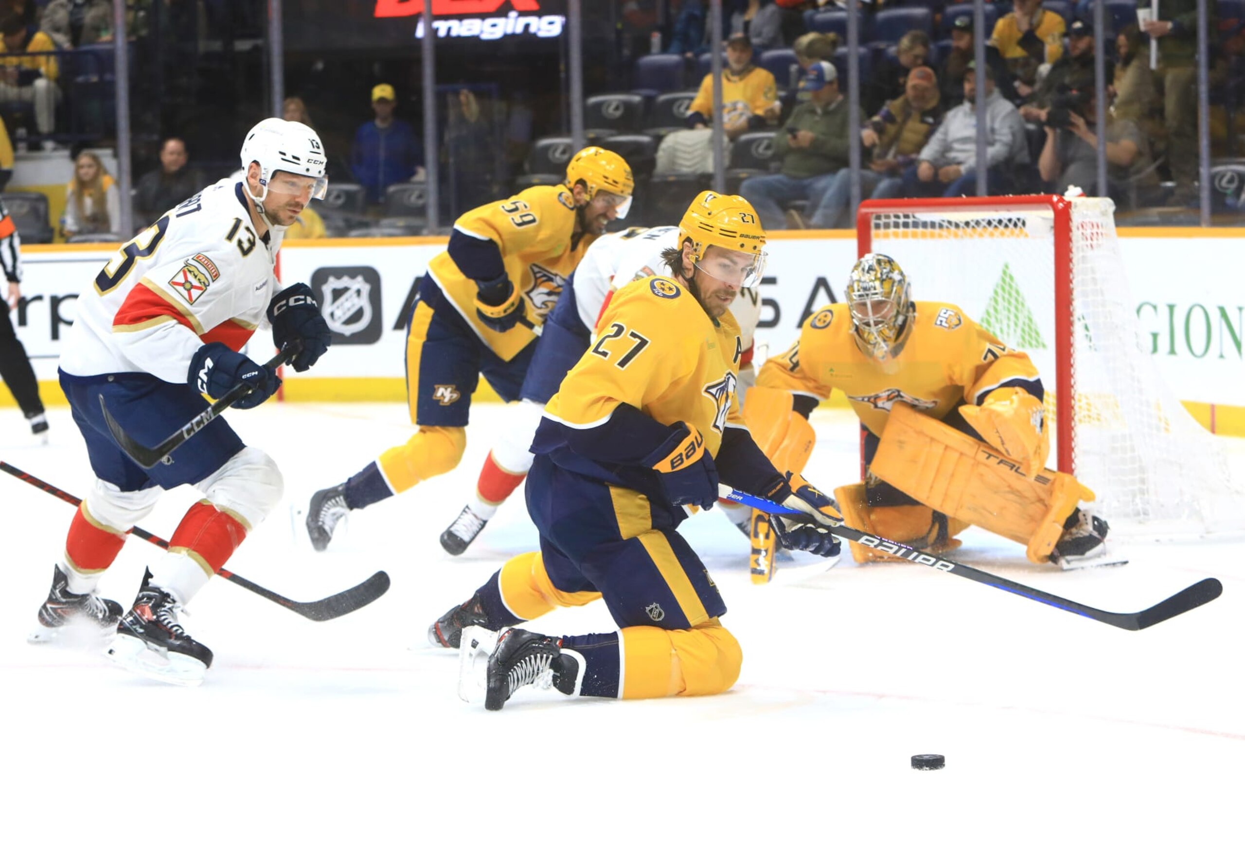 NASHVILLE, TN - JANUARY 22: Florida Panthers right wing Sam Reinhart (13) looks on as Nashville Predators defenseman Ryan McDonagh (27) attempts to play the blocked shot during the NHL game between the Nashville Predators and Florida Panthers, held on January 22, 2024, at Bridgestone Arena in Nashville, Tennessee. (Photo by Danny Murphy/Icon Sportswire via Getty Images)