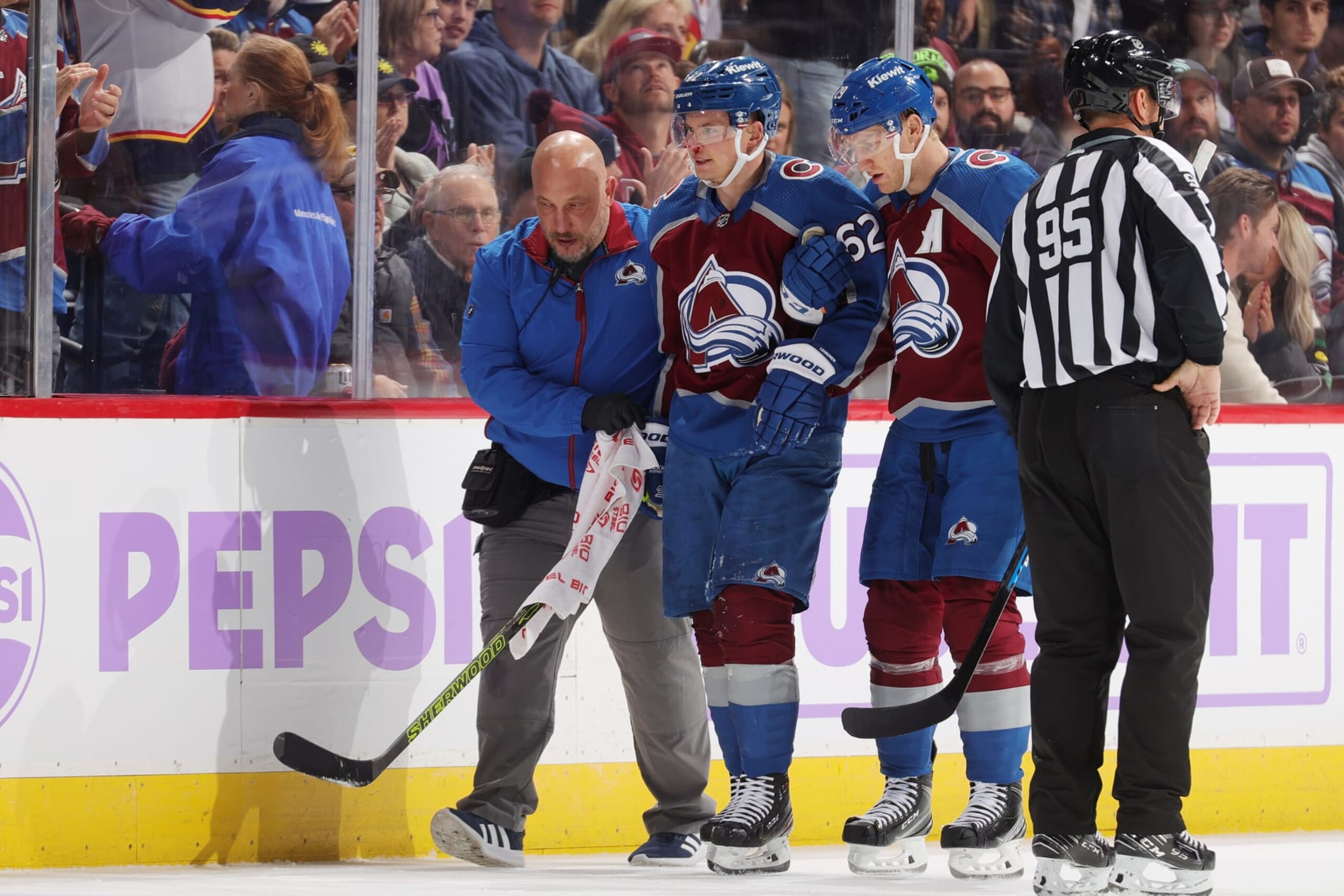 DENVER, COLORADO - NOVEMBER 09: Artturi Lehkonen #62 of the Colorado Avalanche is helped off the ice during the game against the Seattle Kraken at Ball Arena on November 9, 2023 in Denver, Colorado. (Photo by Michael Martin/NHLI via Getty Images)