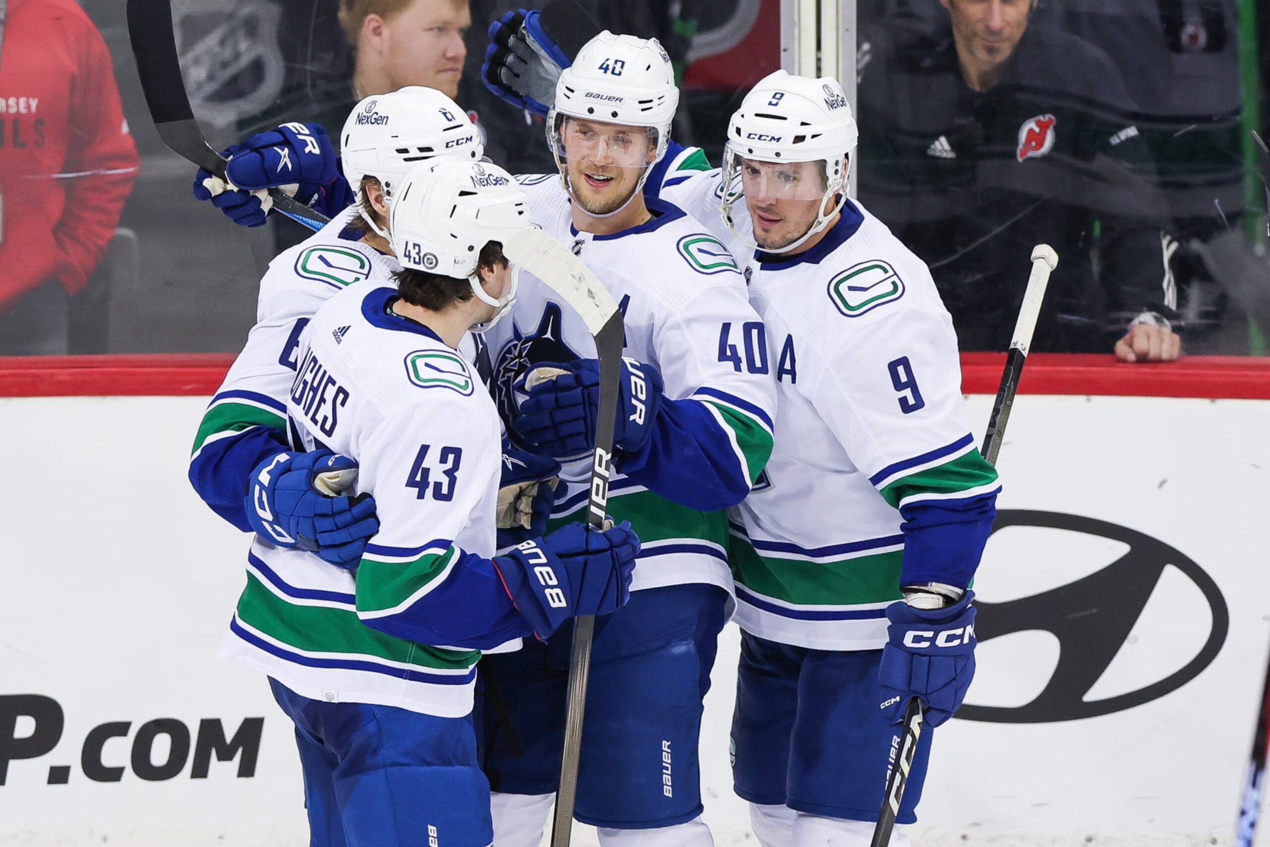 NEWARK, NJ - JANUARY 06: Vancouver Canucks center Elias Pettersson (40) celebrates with Vancouver Canucks defenseman Quinn Hughes (43), Vancouver Canucks right wing Brock Boeser (6) and Vancouver Canucks center J.T. Miller (9) after scoring a goal during a game between the Vancouver Canucks and New Jersey Devils on January 6, 2024 at Prudential Center in the Newark, New Jersey. (Photo by Andrew Mordzynski/Icon Sportswire via Getty Images)