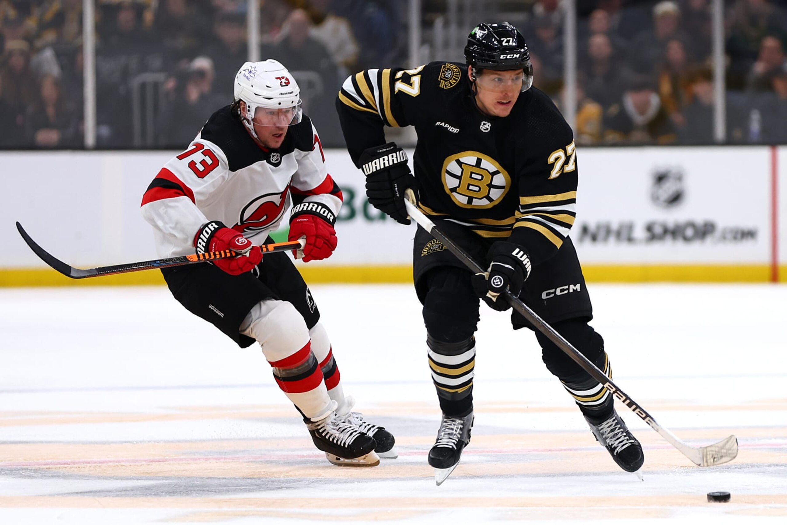BOSTON, MASSACHUSETTS - JANUARY 15: Hampus Lindholm #27 of the Boston Bruins skates against Tyler Toffoli #73 of the New Jersey Devils during the third period at TD Garden on January 15, 2024 in Boston, Massachusetts. The Bruins defeat the Devils 3-0.  (Photo by Maddie Meyer/Getty Images)
