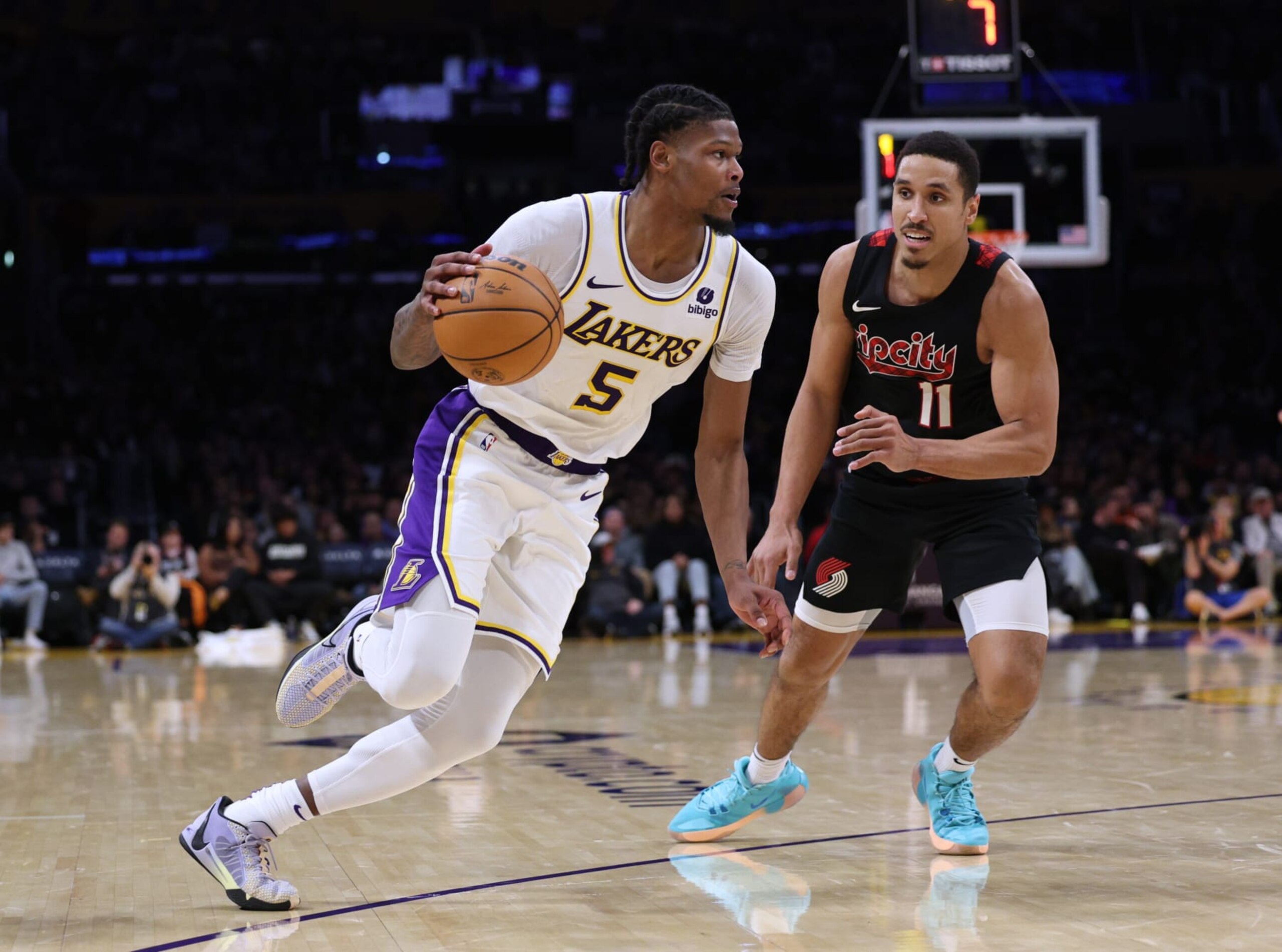 LOS ANGELES, CALIFORNIA - JANUARY 21: Cam Reddish #5 of the Los Angeles Lakers dribbles in front of Malcolm Brogdon #11 of the Portland Trail Blazers during a 134-110 win over the Portland Trail Blazers at Crypto.com Arena on January 21, 2024 in Los Angeles, California. User is consenting to the terms and conditions of the Getty Images License Agreement. (Photo by Harry How/Getty Images)