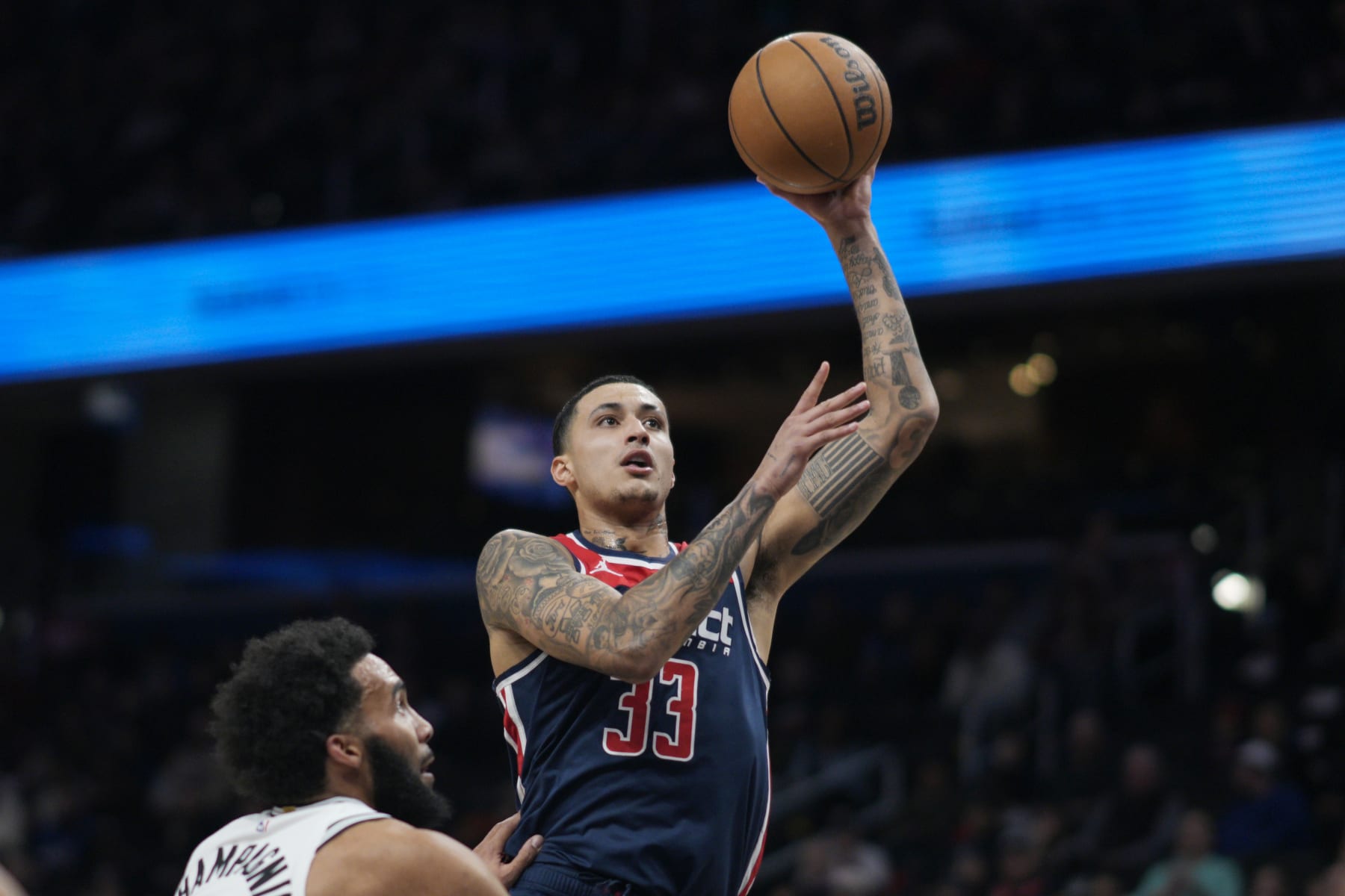 WASHINGTON, DC - JANUARY 20: Kyle Kuzma #33 of the Washington Wizards shoots against Julian Champagnie #30 of the San Antonio Spurs during the first half at Capital One Arena on January 20, 2024 in Washington, DC. NOTE TO USER: User expressly acknowledges and agrees that, by downloading and or using this photograph, User is consenting to the terms and conditions of the Getty Images License Agreement. (Photo by Jess Rapfogel/Getty Images)