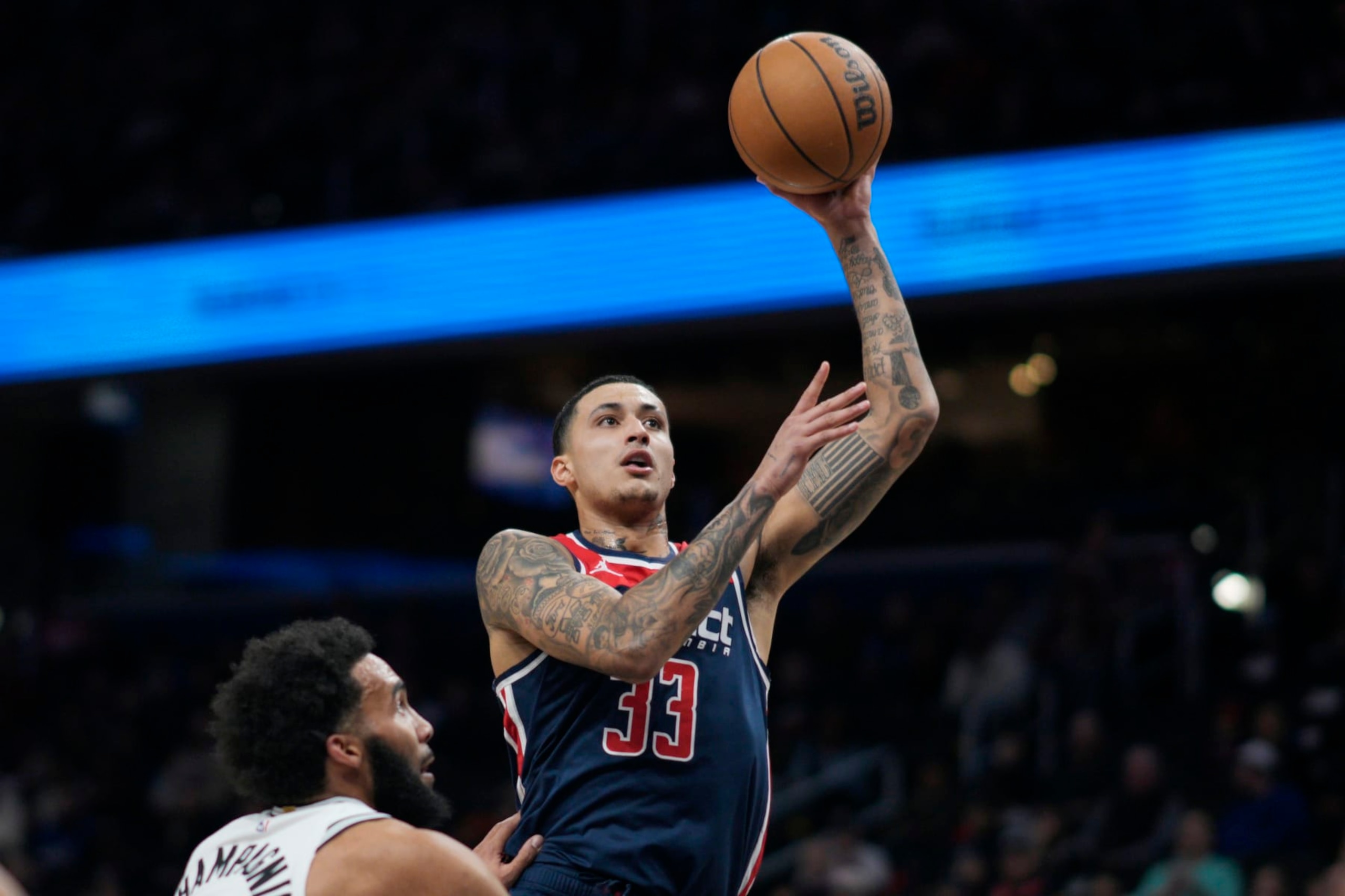 WASHINGTON, DC - JANUARY 20: Kyle Kuzma #33 of the Washington Wizards shoots against Julian Champagnie #30 of the San Antonio Spurs during the first half at Capital One Arena on January 20, 2024 in Washington, DC. NOTE TO USER: User expressly acknowledges and agrees that, by downloading and or using this photograph, User is consenting to the terms and conditions of the Getty Images License Agreement. (Photo by Jess Rapfogel/Getty Images)