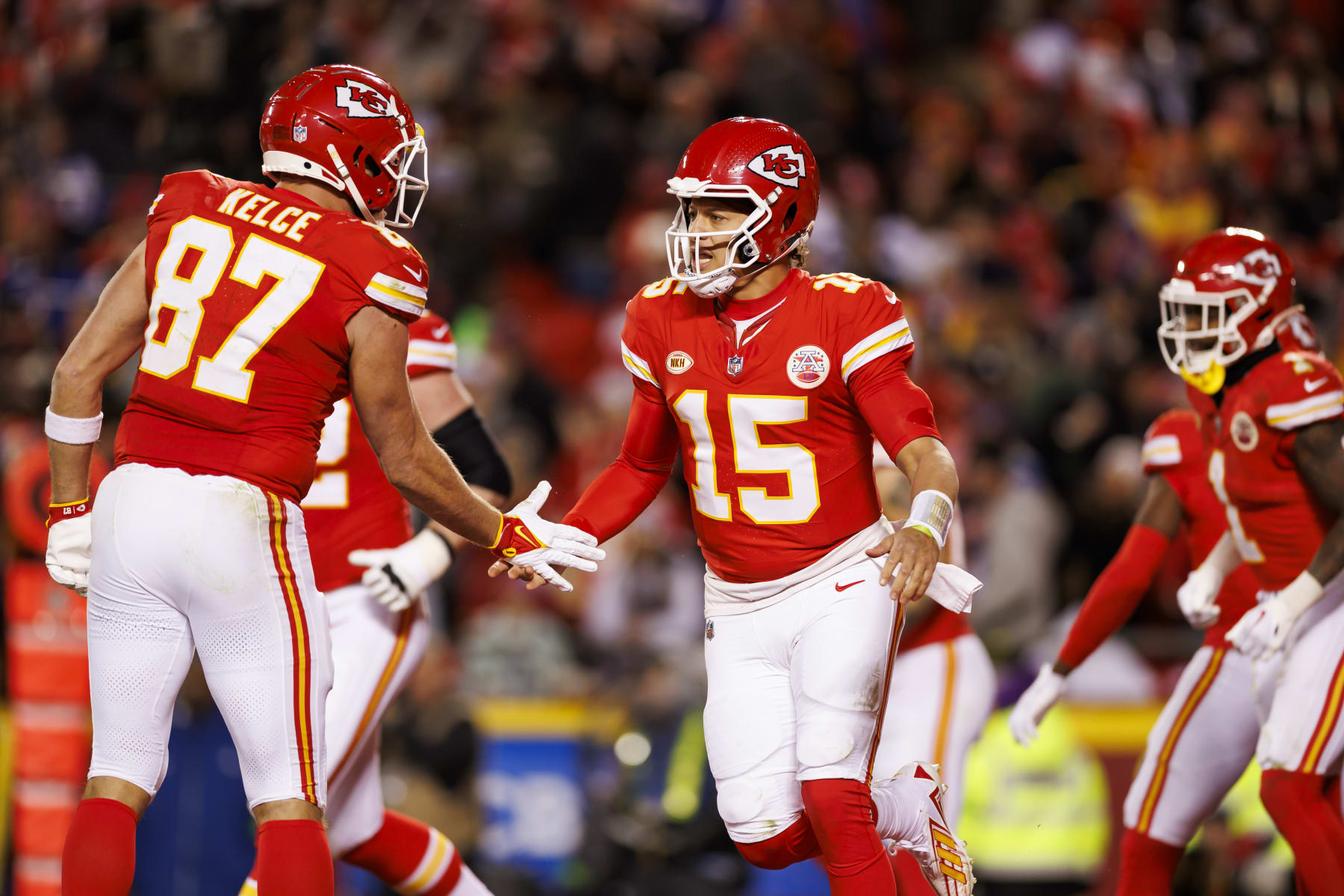 KANSAS CITY, MISSOURI - DECEMBER 10: Patrick Mahomes #15 of the Kansas City Chiefs celebrates with Travis Kelce #87 of the Kansas City Chiefs after the team scored a touchdown during an NFL football game against the Buffalo Bills at GEHA Field at Arrowhead Stadium on December 10, 2023 in Kansas City, Missouri. (Photo by Ryan Kang/Getty Images)
