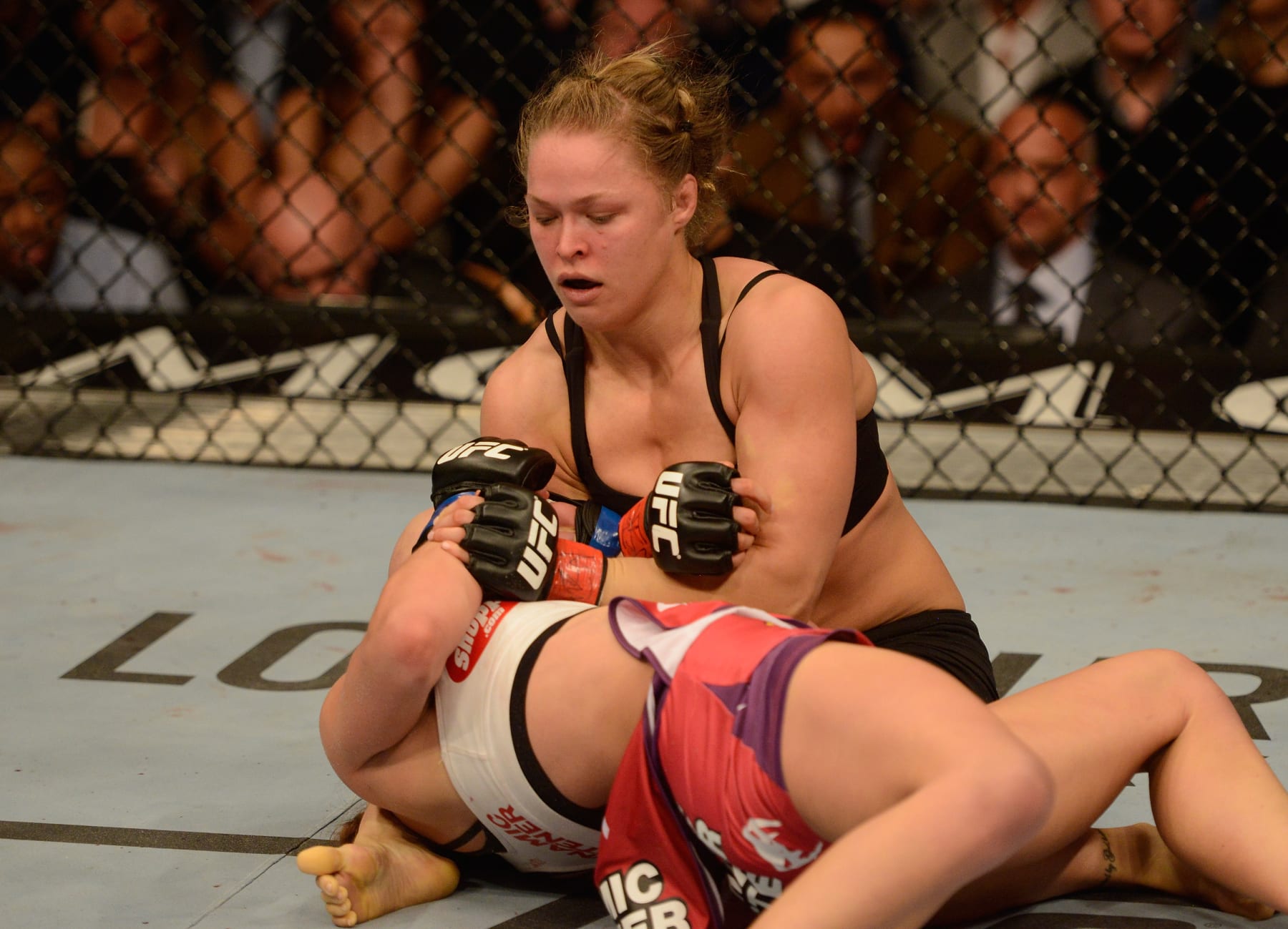LAS VEGAS, NV - DECEMBER 28:  Ronda Rousey (top) attempts to submit Miesha Tate in their UFC women's bantamweight championship bout during the UFC 168 event at the MGM Grand Garden Arena on December 28, 2013 in Las Vegas, Nevada. (Photo by Donald Miralle/Zuffa LLC/Zuffa LLC via Getty Images)