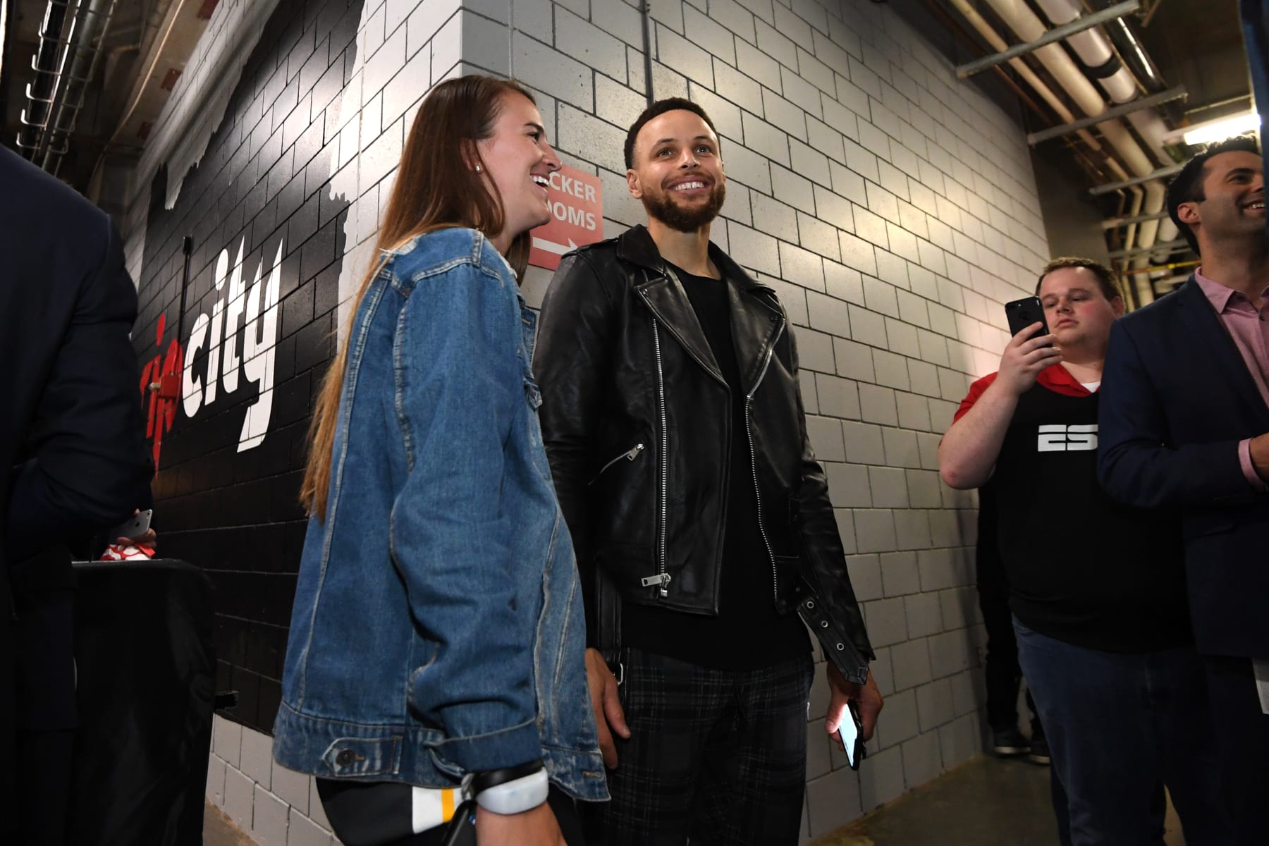 PORTLAND, OR - MAY 20: Stephen Curry #30 of the Golden State Warriors shares a laugh with Oregon Ducks Basketball Player, Sabrina Ionescu, after advancing to the NBA Finals against the Portland Trail Blazers during Game Four of the Western Conference Finals on May 20, 2019 at the Moda Center in Portland, Oregon. NOTE TO USER: User expressly acknowledges and agrees that, by downloading and/or using this photograph, user is consenting to the terms and conditions of the Getty Images License Agreement. Mandatory Copyright Notice: Copyright 2019 NBAE (Photo by Noah Graham/NBAE via Getty Images)