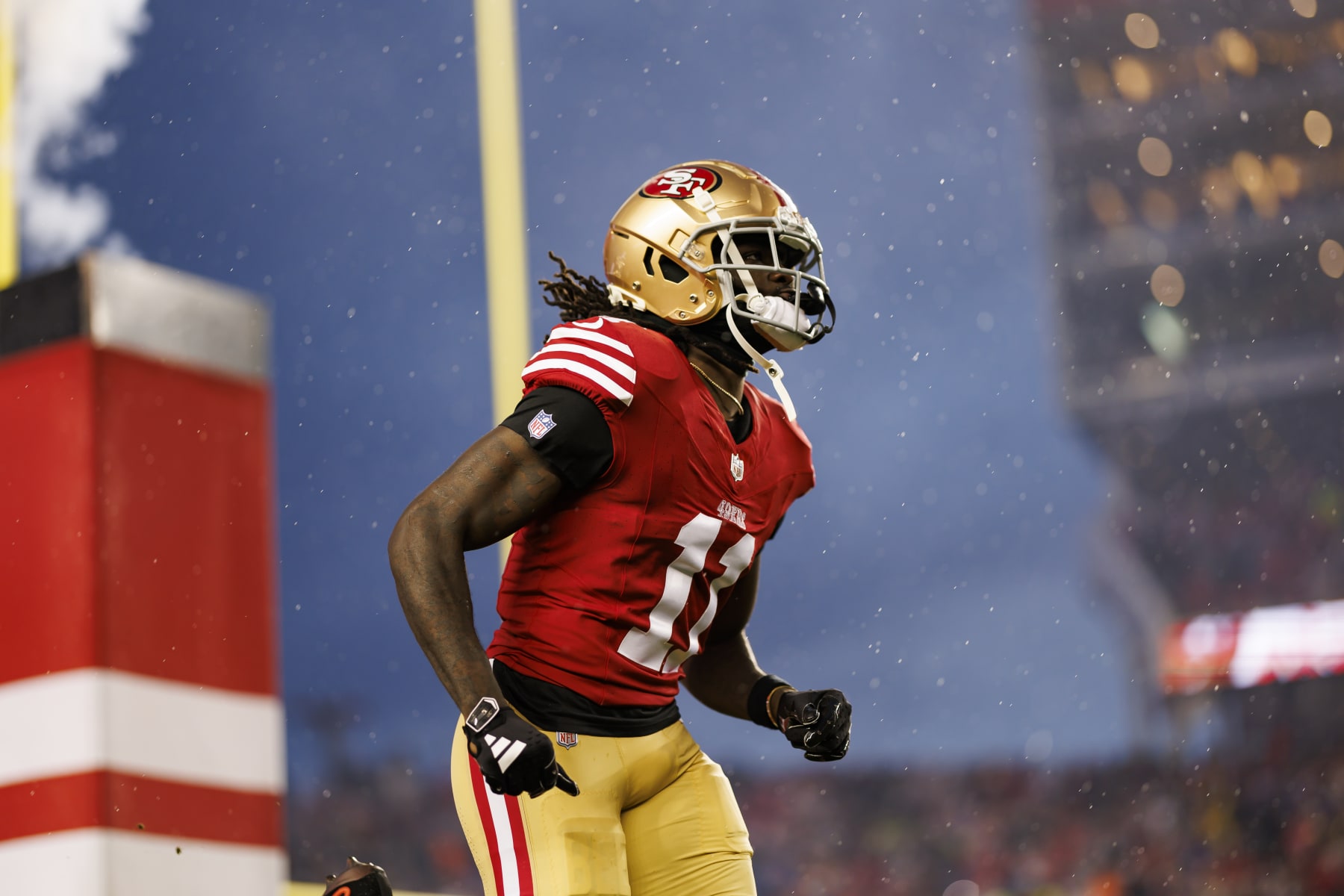SANTA CLARA, CALIFORNIA - JANUARY 20: Brandon Aiyuk #11 of the San Francisco 49ers runs onto the field during player introductions before an NFC divisional round playoff football game against the Green Bay Packers at Levi's Stadium on January 20, 2024 in Santa Clara, California. (Photo by Ryan Kang/Getty Images)