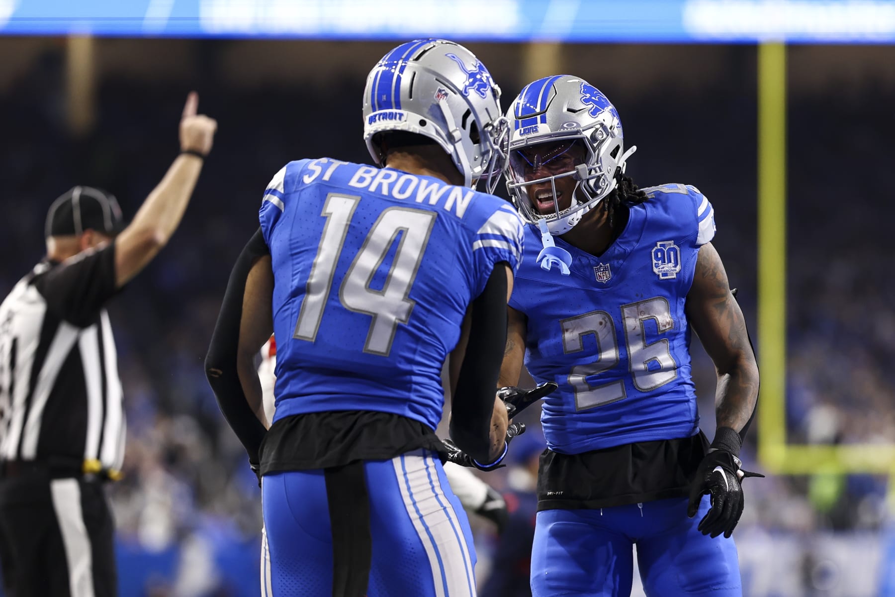 DETROIT, MI - JANUARY 21: Amon-Ra St. Brown #14 of the Detroit Lions celebrates with Jahmyr Gibbs #26 after a play during the third quarter of an NFL divisional round playoff football game against the Tampa Bay Buccaneers at Ford Field on January 21, 2024 in Detroit, Michigan. (Photo by Kevin Sabitus/Getty Images)