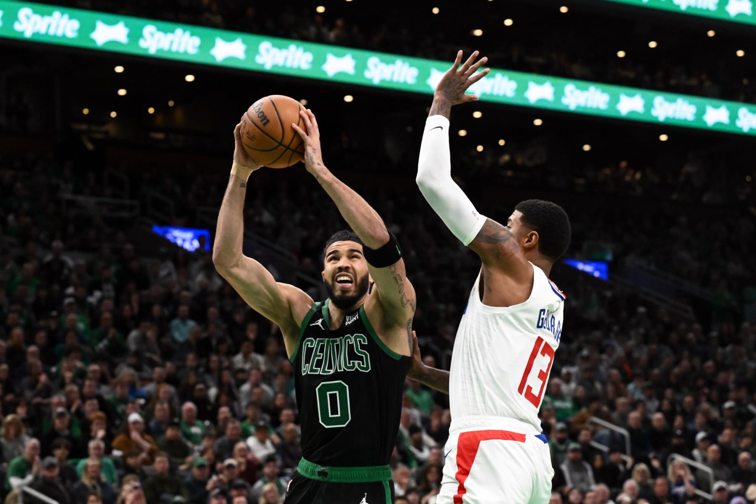 BOSTON, MASSACHUSETTS - JANUARY 27: Jayson Tatum #0 of the Boston Celtics attempts a basket against Paul George #13 of the LA Clippers during the second quarter at the TD Garden on January 27, 2024 in Boston, Massachusetts. NOTE TO USER: User expressly acknowledges and agrees that, by downloading and or using this photograph, User is consenting to the terms and conditions of the Getty Images License Agreement. (Photo by Brian Fluharty/Getty Images)