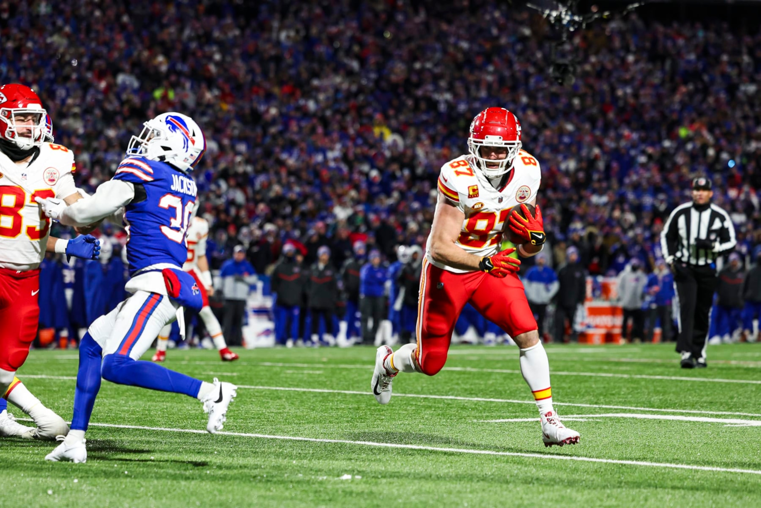 ORCHARD PARK, NY - JANUARY 21: Travis Kelce #87 of the Kansas City Chiefs runs the ball for a touchdown during an NFL divisional round playoff football game against the Buffalo Bills at Highmark Stadium on January 21, 2024 in Orchard Park, New York. (Photo by Perry Knotts/Getty Images)