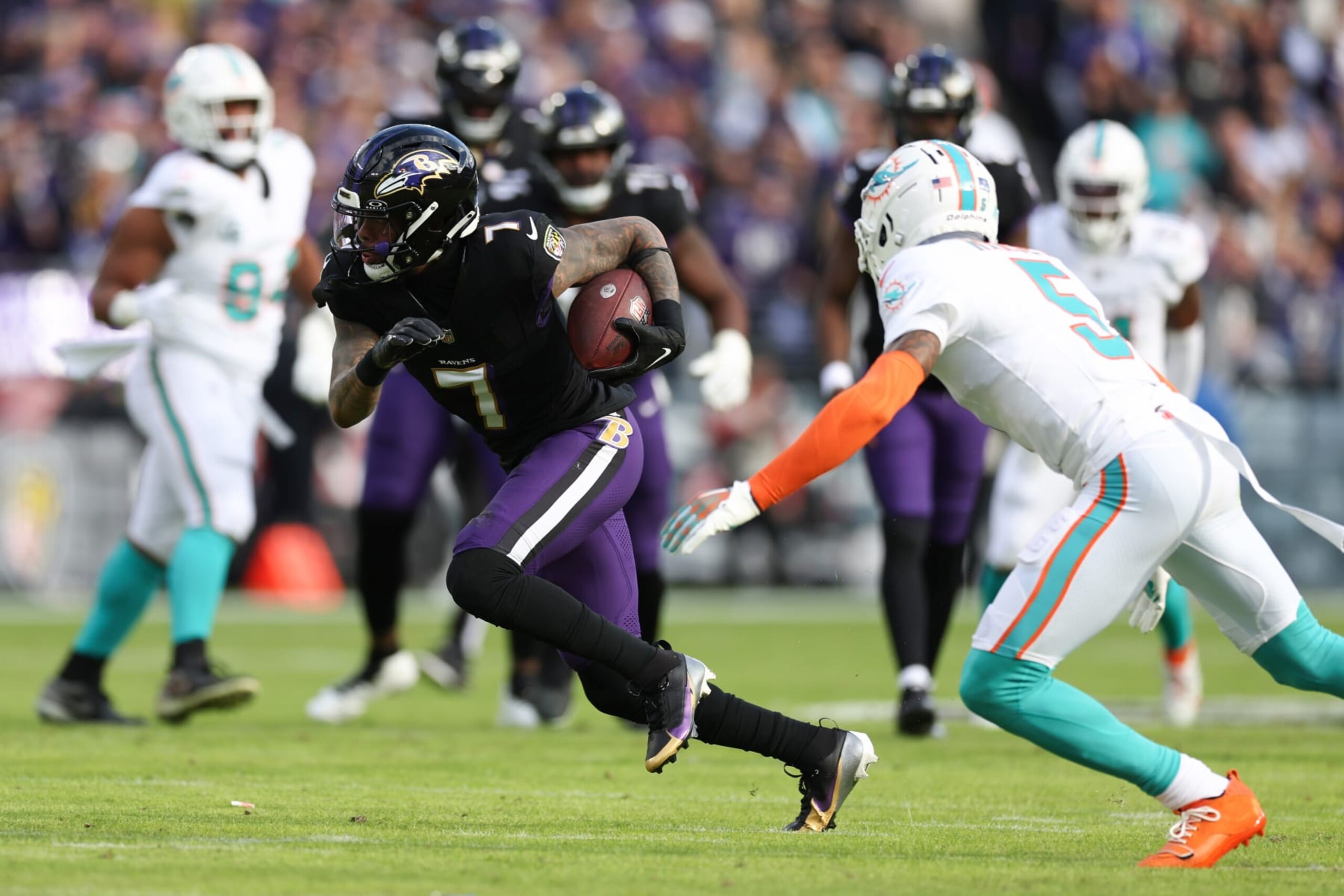 BALTIMORE, MARYLAND - DECEMBER 31: Rashod Bateman #7 of the Baltimore Ravens carries the ball against the Miami Dolphins during the first half of the game at M&T Bank Stadium on December 31, 2023 in Baltimore, Maryland. (Photo by Todd Olszewski/Getty Images)