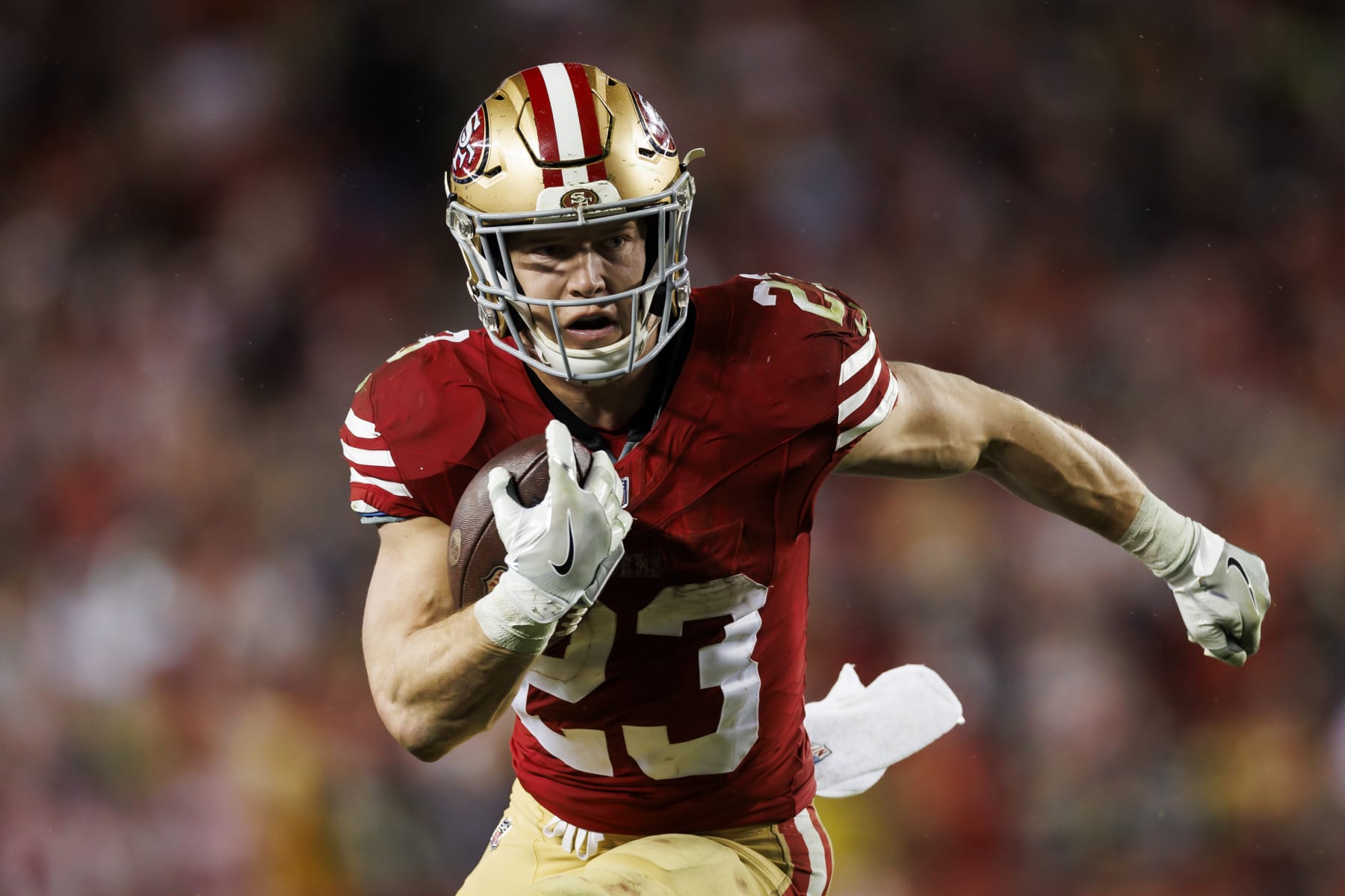 SANTA CLARA, CALIFORNIA - JANUARY 20: Christian McCaffrey #23 of the San Francisco 49ers carries the ball on a run play during an NFC divisional round playoff football game against the Green Bay Packers at Levi's Stadium on January 20, 2024 in Santa Clara, California. (Photo by Ryan Kang/Getty Images)