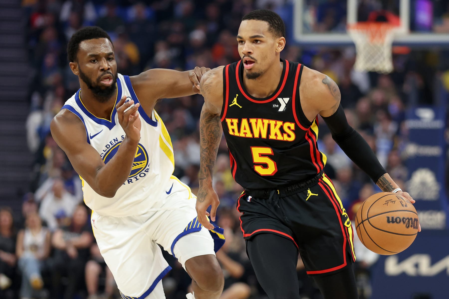 SAN FRANCISCO, CALIFORNIA - JANUARY 24: Dejounte Murray #5 of the Atlanta Hawks is guarded by Andrew Wiggins #22 of the Golden State Warriors in the first half at Chase Center on January 24, 2024 in San Francisco, California. NOTE TO USER: User expressly acknowledges and agrees that, by downloading and or using this photograph, User is consenting to the terms and conditions of the Getty Images License Agreement.  (Photo by Ezra Shaw/Getty Images)
