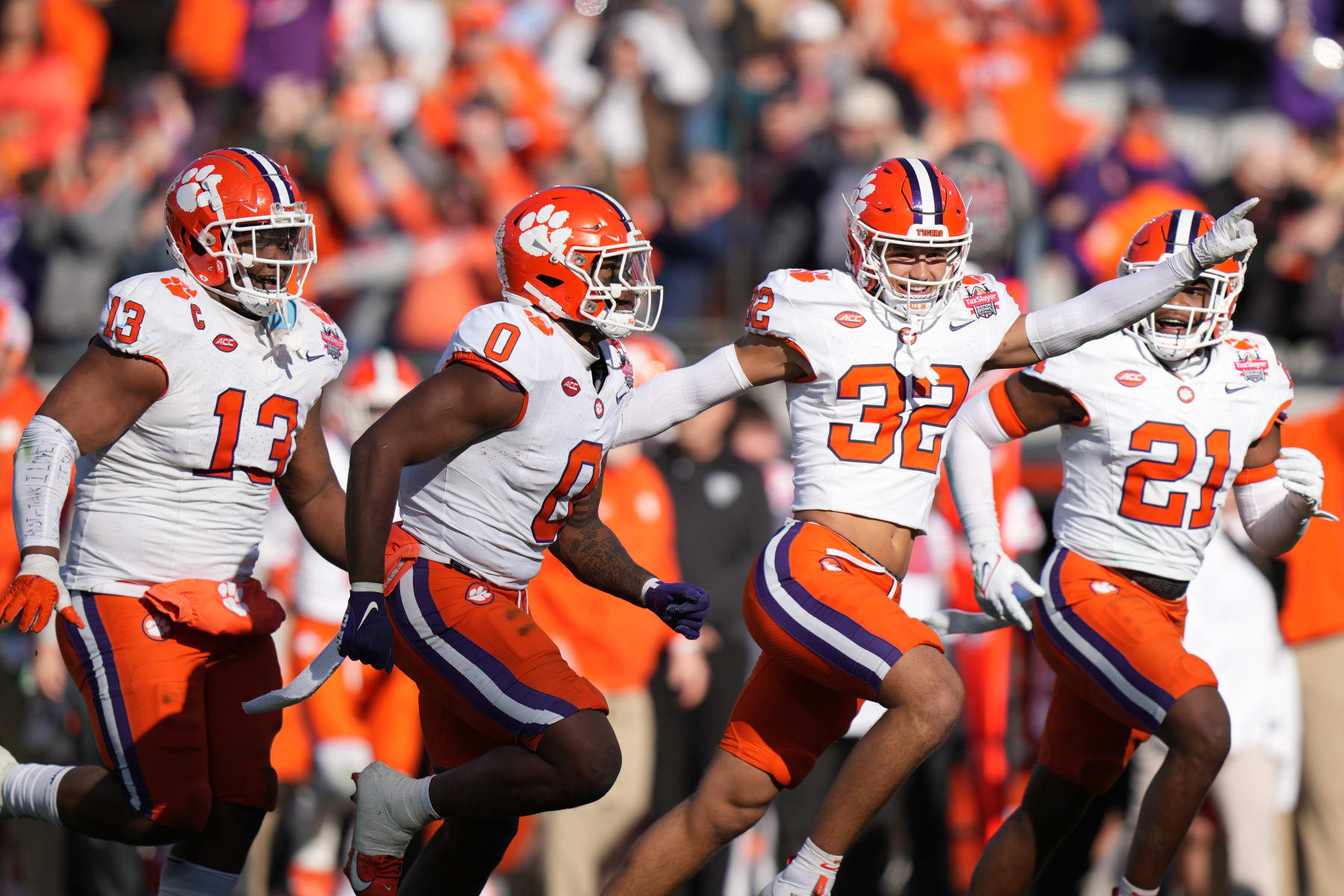 JACKSONVILLE, FL - DECEMBER 29: Clemson Tigers linebacker Barrett Carter (0)  celebrates his fumble recovery with Clemson Tigers linebacker Jamal Anderson (32) and other teammates in the second half during the TaxSlayer Gator Bowl between the Clemson Tigers and the Kentucky Wildcats on Friday, December 29, 2023 at EverBank Stadium, Jacksonville, Fla. (Photo by Peter Joneleit/Icon Sportswire via Getty Images)