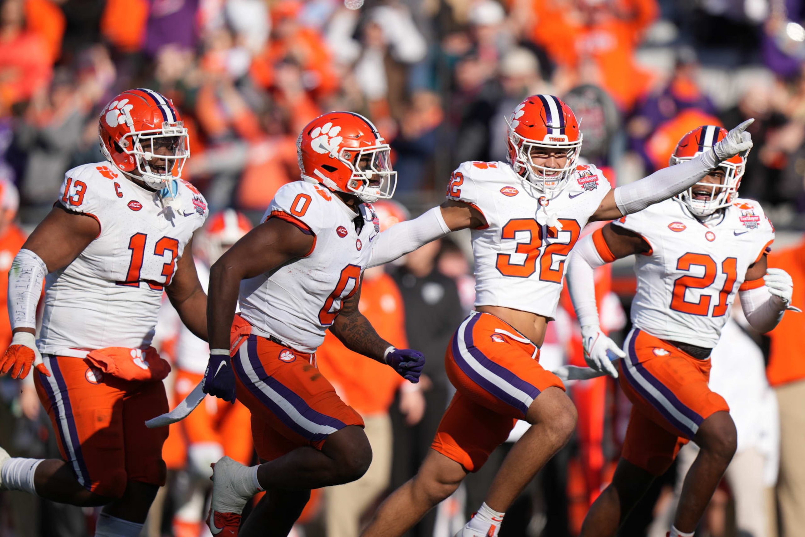 JACKSONVILLE, FL - DECEMBER 29: Clemson Tigers linebacker Barrett Carter (0)  celebrates his fumble recovery with Clemson Tigers linebacker Jamal Anderson (32) and other teammates in the second half during the TaxSlayer Gator Bowl between the Clemson Tigers and the Kentucky Wildcats on Friday, December 29, 2023 at EverBank Stadium, Jacksonville, Fla. (Photo by Peter Joneleit/Icon Sportswire via Getty Images)