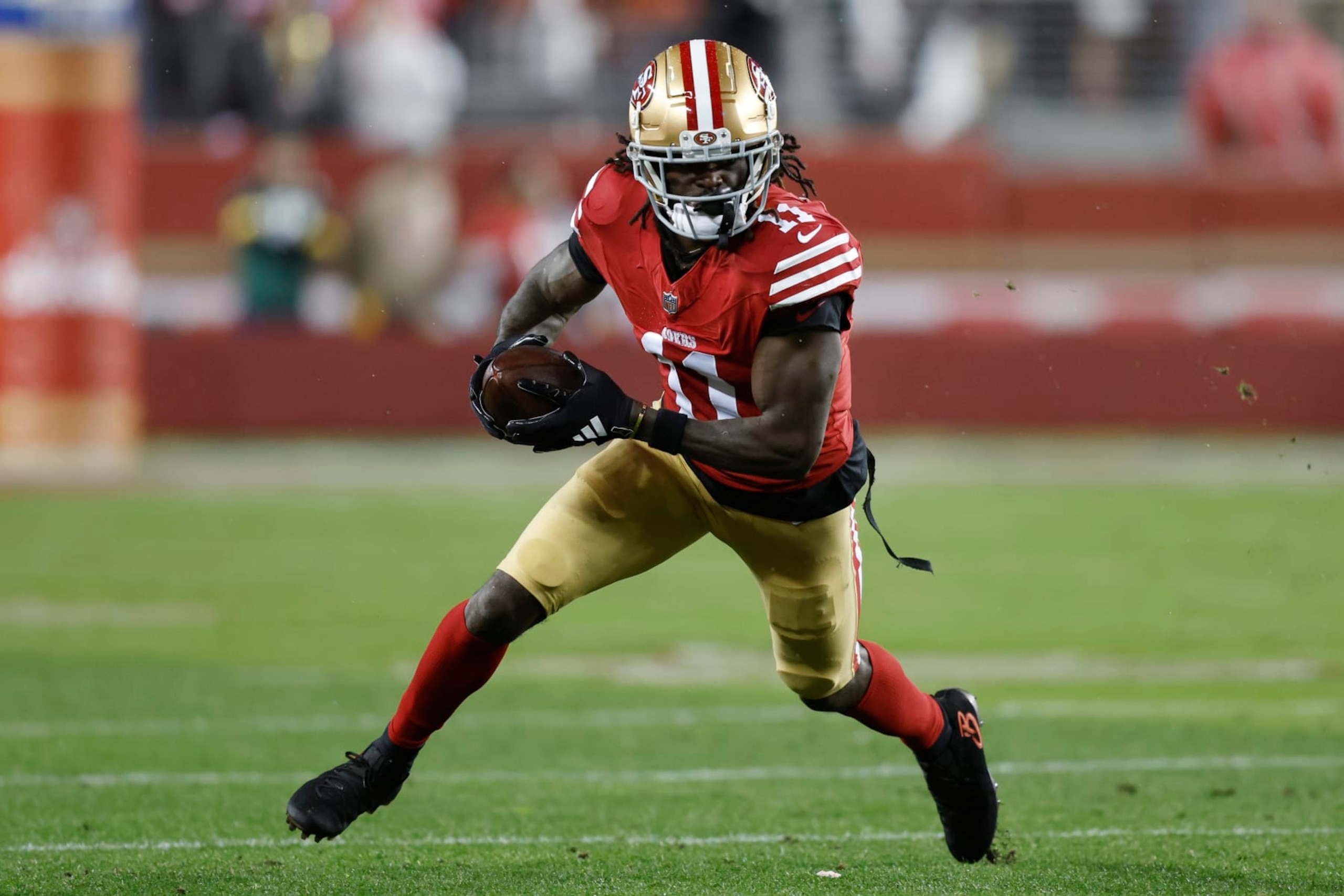 SANTA CLARA, CALIFORNIA - JANUARY 20: Brandon Aiyuk #11 of the San Francisco 49ers runs with the ball during the first half against the Green Bay Packers in the NFC Divisional Playoffs at Levi's Stadium on January 20, 2024 in Santa Clara, California. (Photo by Lachlan Cunningham/Getty Images)