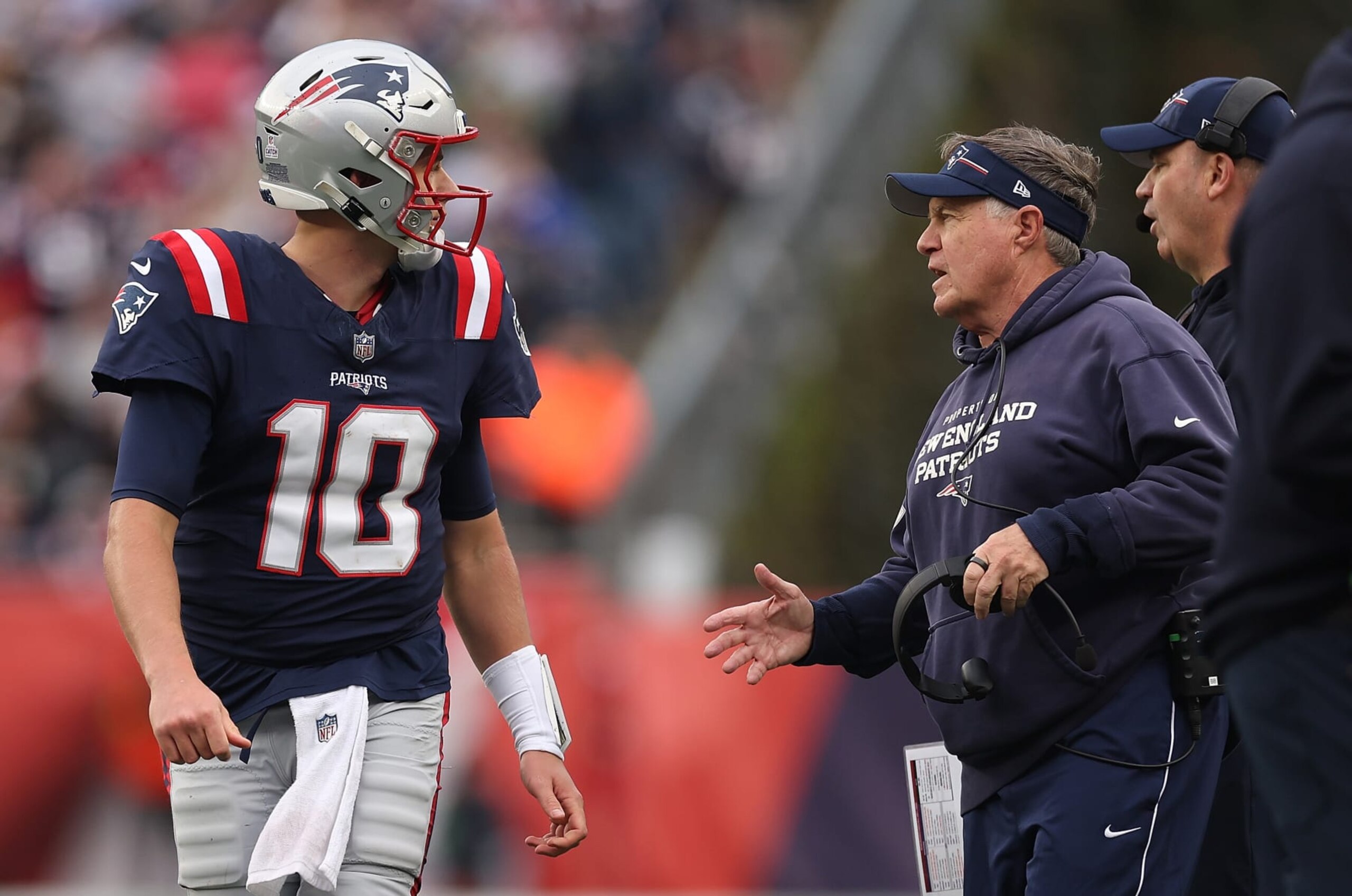 FOXBOROUGH, MASSACHUSETTS - OCTOBER 22: Head coach Bill Belichick of the New England Patriots speaks with Mac Jones #10 in the second half of the game against the Buffalo Bills at Gillette Stadium on October 22, 2023 in Foxborough, Massachusetts. (Photo by Maddie Meyer/Getty Images)