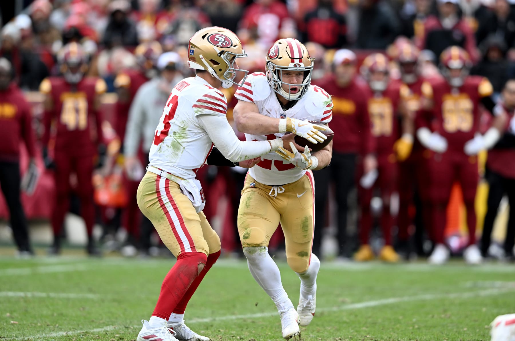 LANDOVER, MARYLAND - DECEMBER 31: Brock Purdy #13 of the San Francisco 49ers hands the ball off to Christian McCaffrey #23 during the game against the Washington Commanders at FedExField on December 31, 2023 in Landover, Maryland. (Photo by G Fiume/Getty Images)