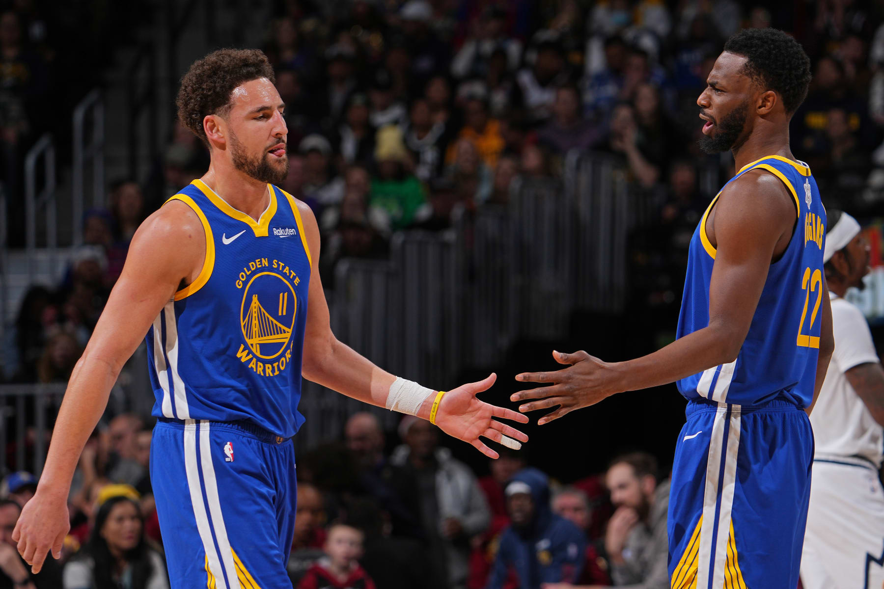 DENVER, CO - DECEMBER 25: Klay Thompson #11 and Andrew Wiggins #22 of the Golden State Warriors high five during the game against the Denver Nuggets on December 25, 2023 at the Ball Arena in Denver, Colorado. NOTE TO USER: User expressly acknowledges and agrees that, by downloading and/or using this Photograph, user is consenting to the terms and conditions of the Getty Images License Agreement. Mandatory Copyright Notice: Copyright 2023 NBAE (Photo by Bart Young/NBAE via Getty Images)