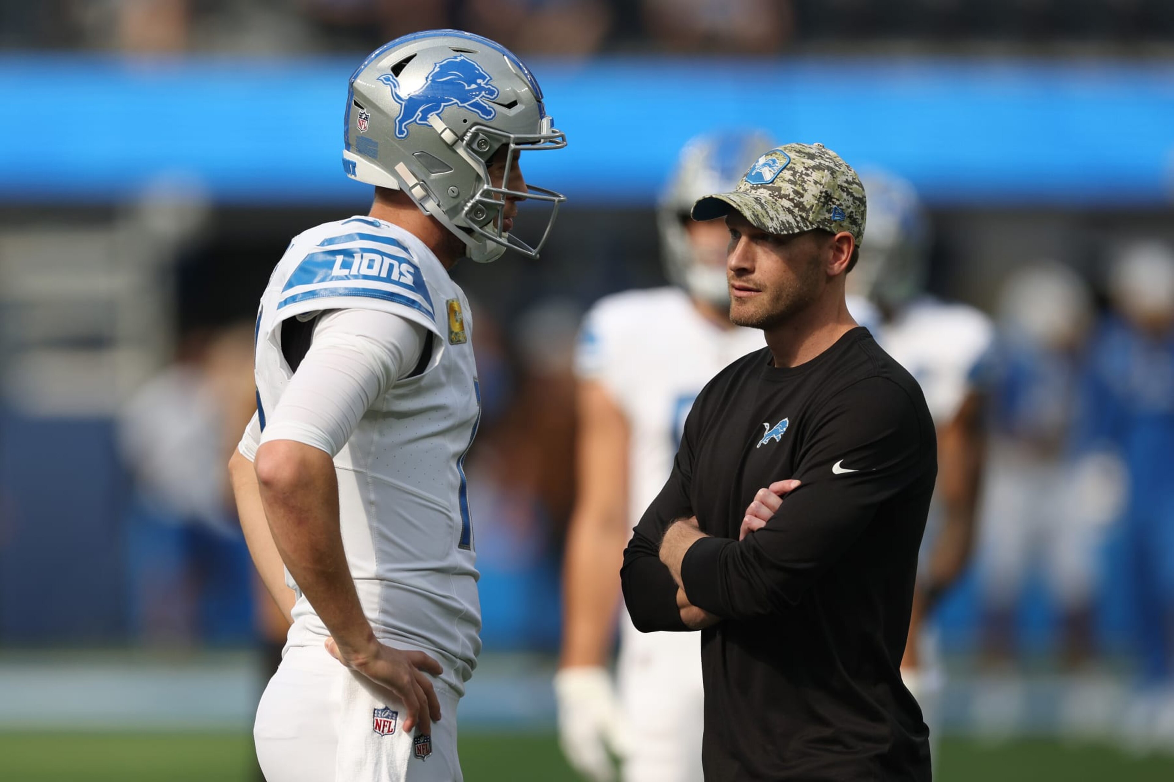 INGLEWOOD, CALIFORNIA - NOVEMBER 12: Jared Goff #16 of the Detroit Lions talks with offensive coordinator Ben Johnson before the game against the Los Angeles Chargers at SoFi Stadium on November 12, 2023 in Inglewood, California. (Photo by Harry How/Getty Images)