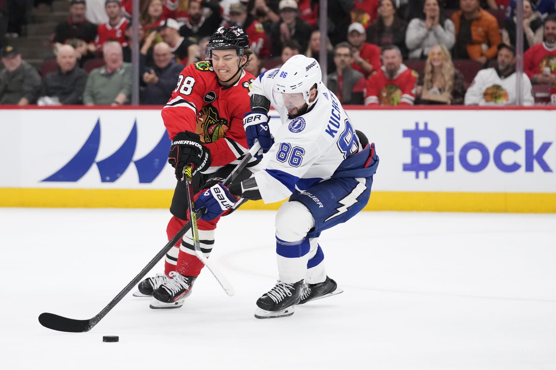 Chicago Blackhawks center Connor Bedard challenges Tampa Bay Lightning winger Nikita Kucherov. 