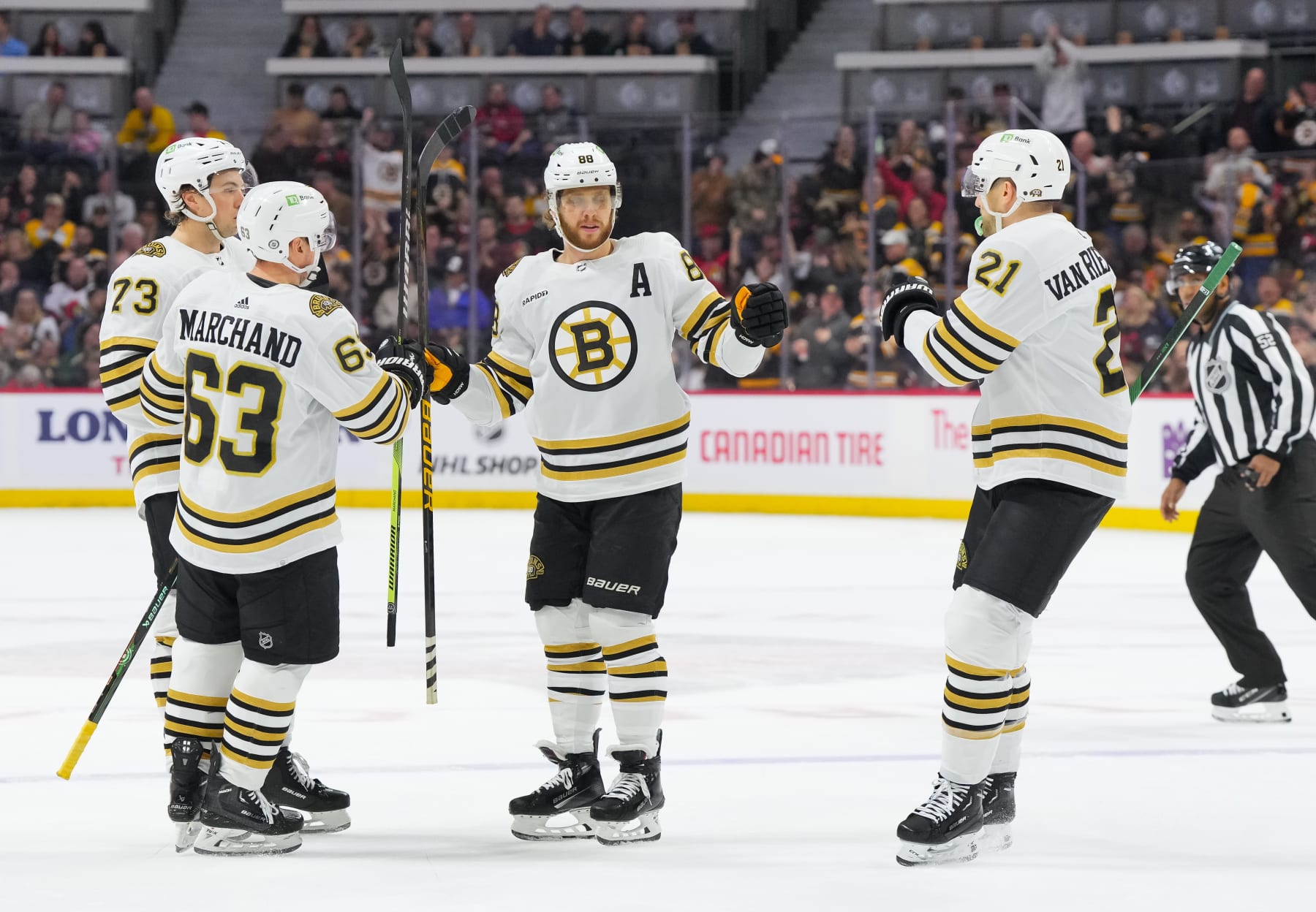 OTTAWA, CANADA - JANUARY 25: David Pastrnak #88 of the Boston Bruins celebrates his first period goal against the Ottawa Senators with Charlie McAvoy #73, James van Riemsdyk #21 and Brad Marchand #63 at Canadian Tire Centre on January 25, 2024 in Ottawa, Ontario, Canada. (Photo by Chris Tanouye/Freestyle Photography/Getty Images)